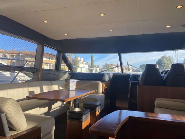 Luxurious interior of 2013 Princess 52 Flybridge yacht with elegant seating and panoramic windows.