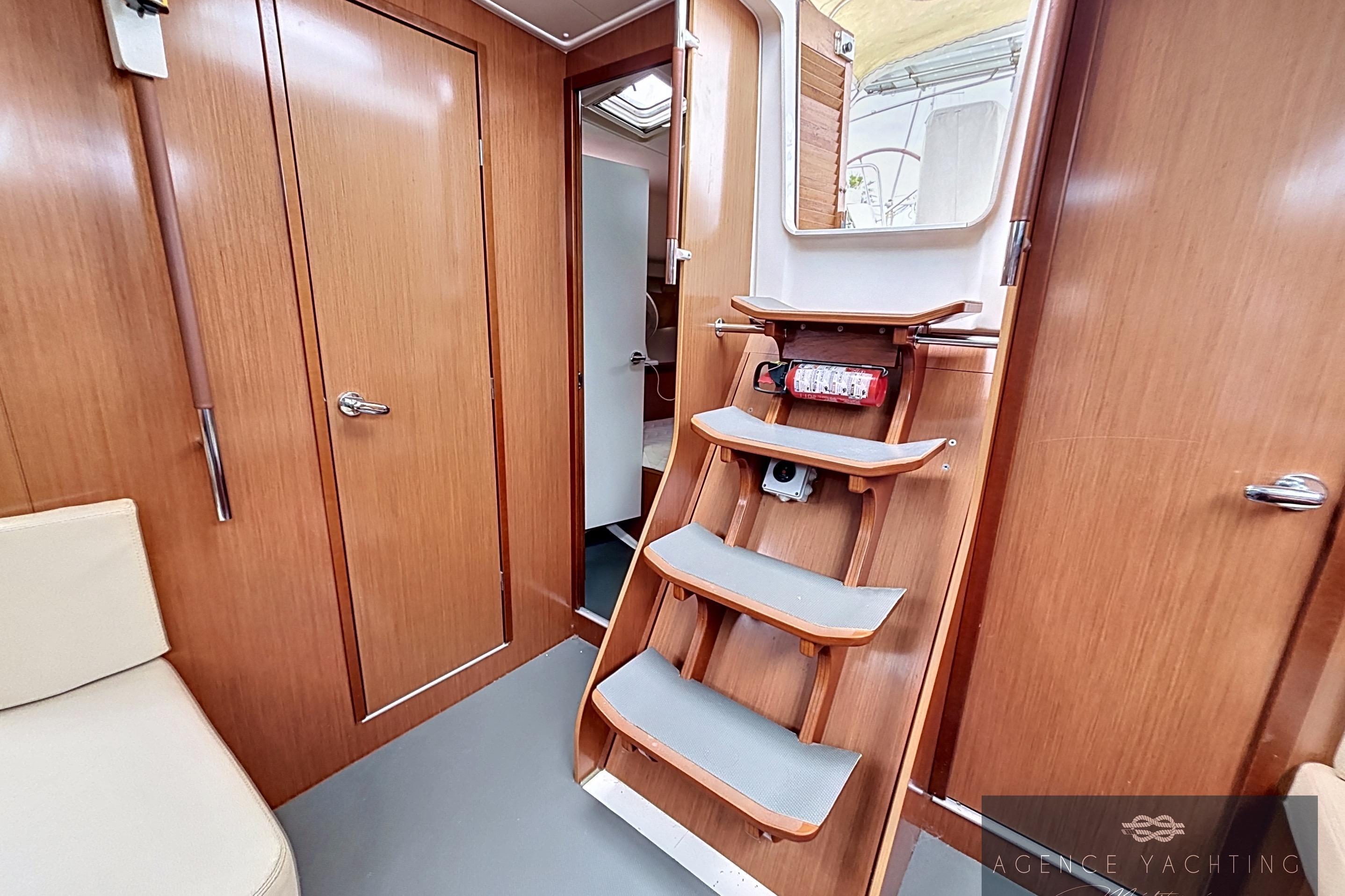 Interior of 2008 Beneteau Oceanis 40 yacht with wooden finish and staircase.