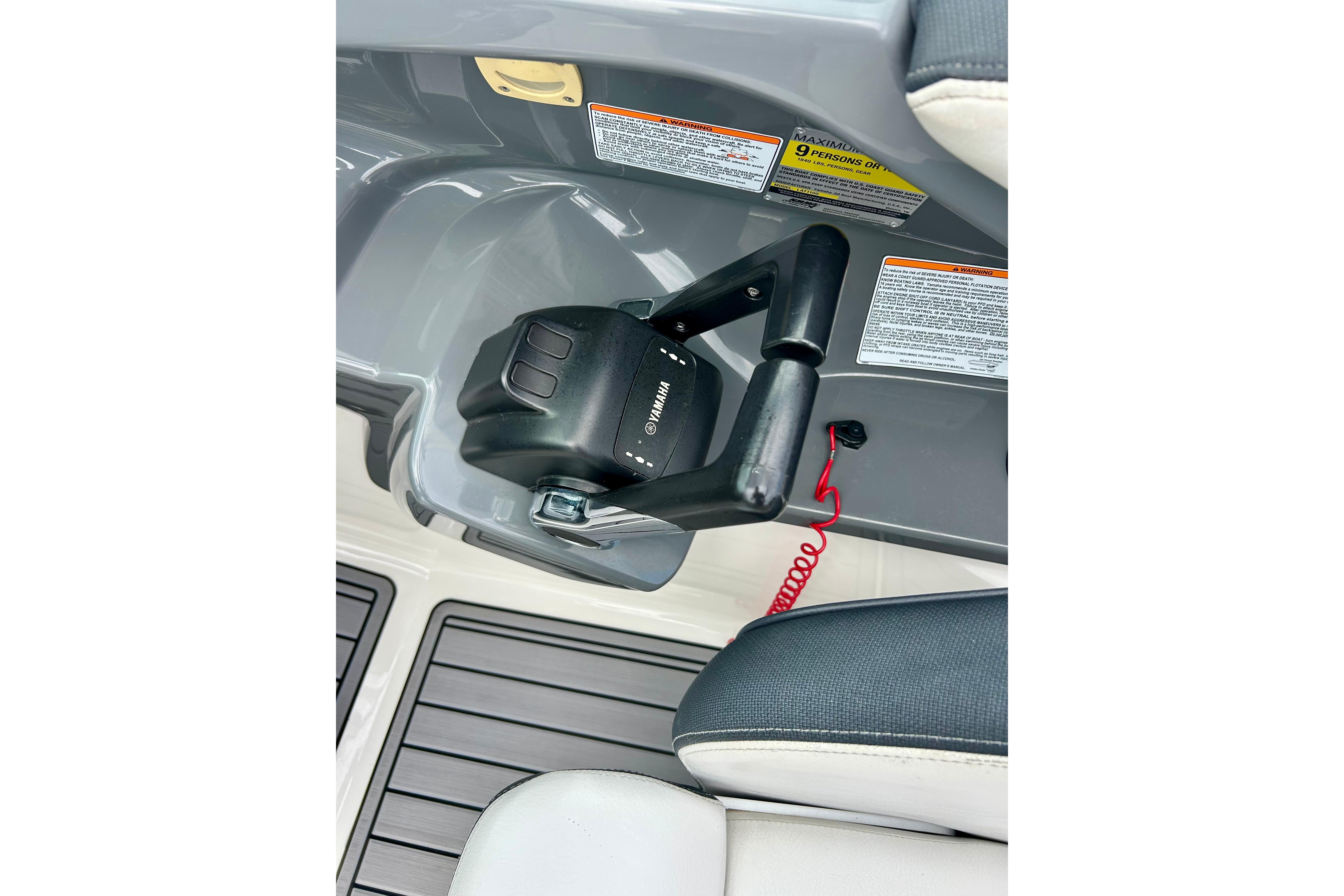Yamaha AR210 2015 boat throttle control with safety lanyard and warning labels.