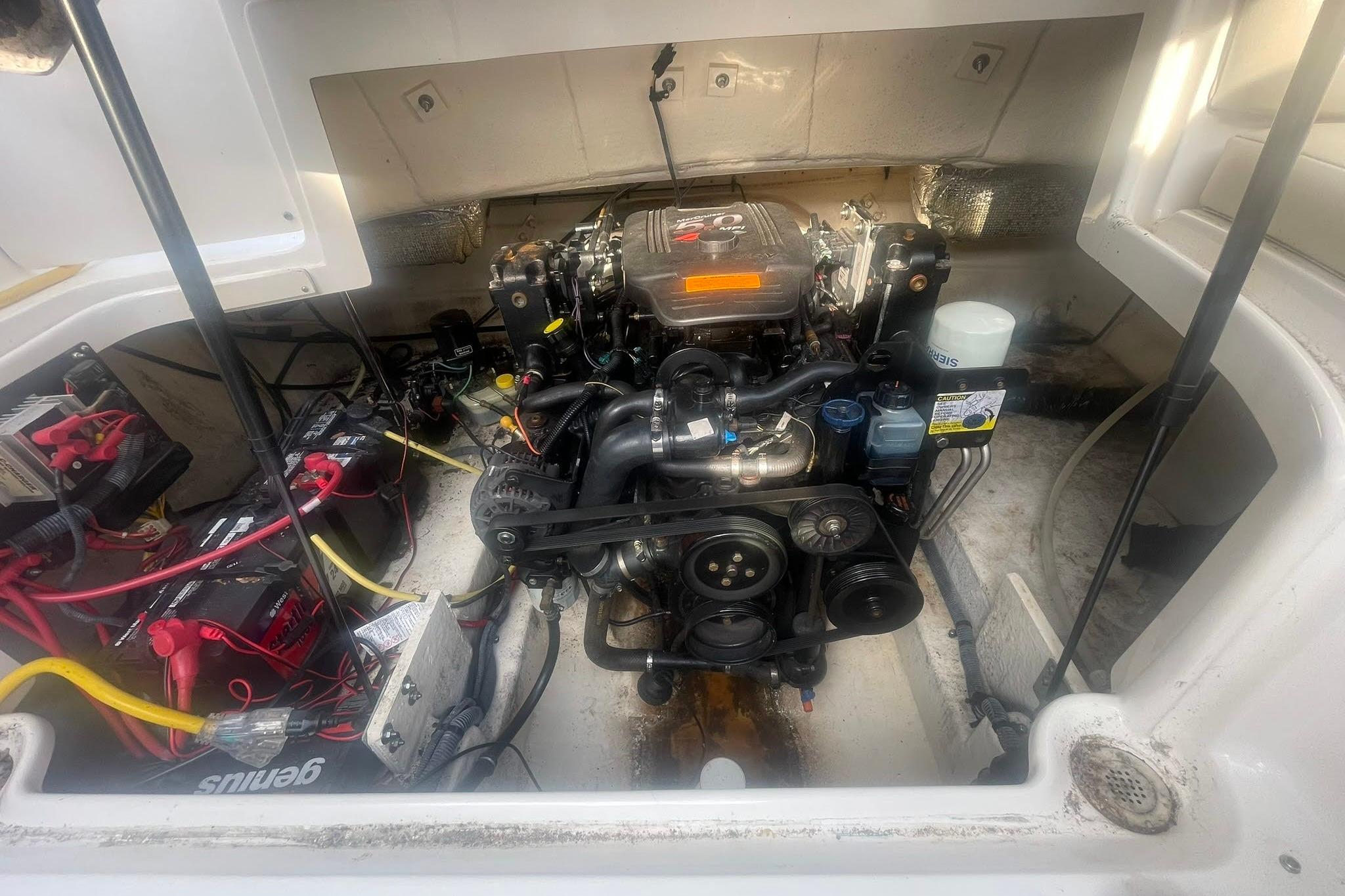 Engine compartment of a 2003 Chaparral 235 SSi boat, showing detailed mechanical components.