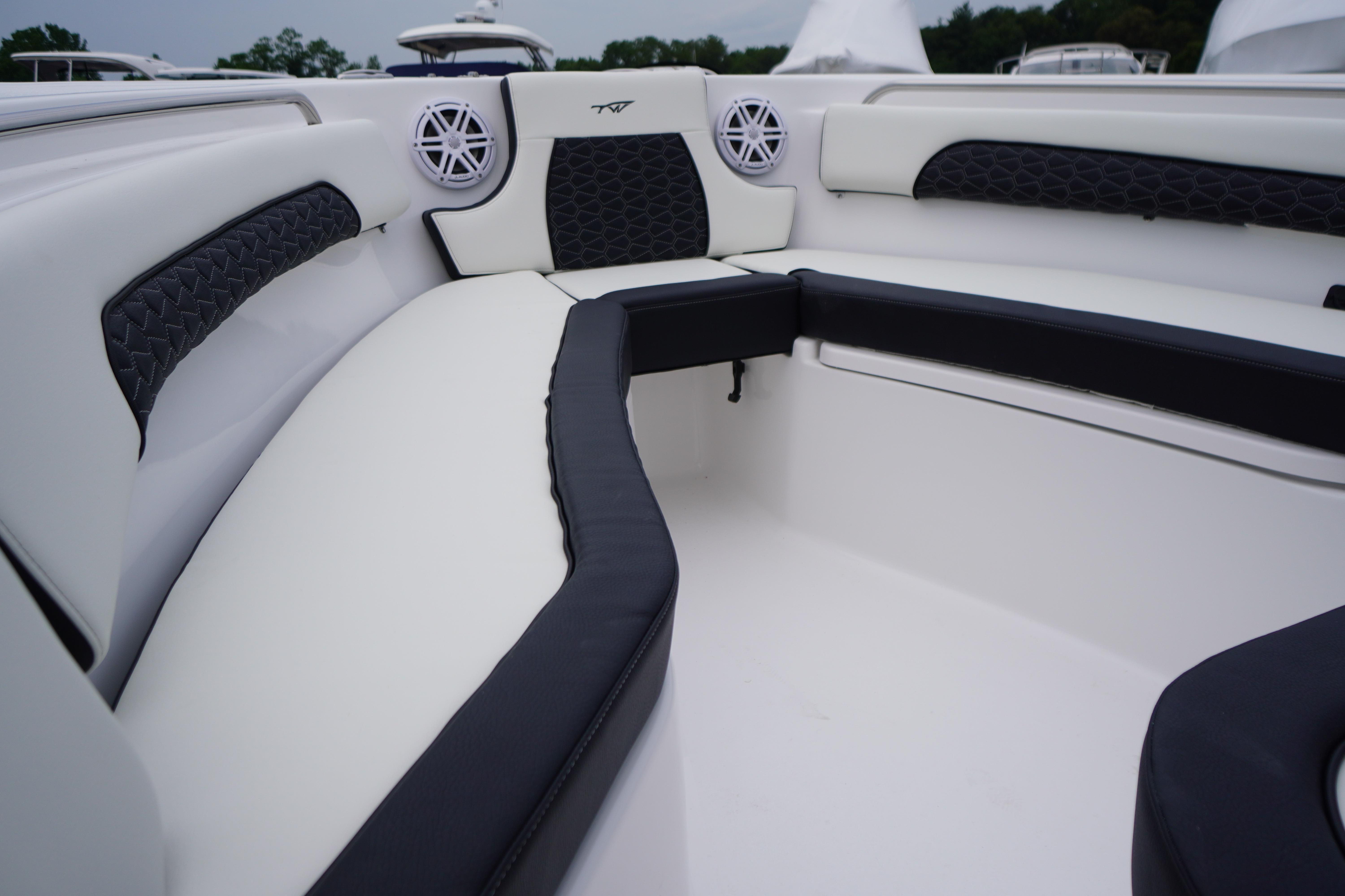 Interior of 2026 Tidewater 232 SS boat with cushioned seating and speakers.
