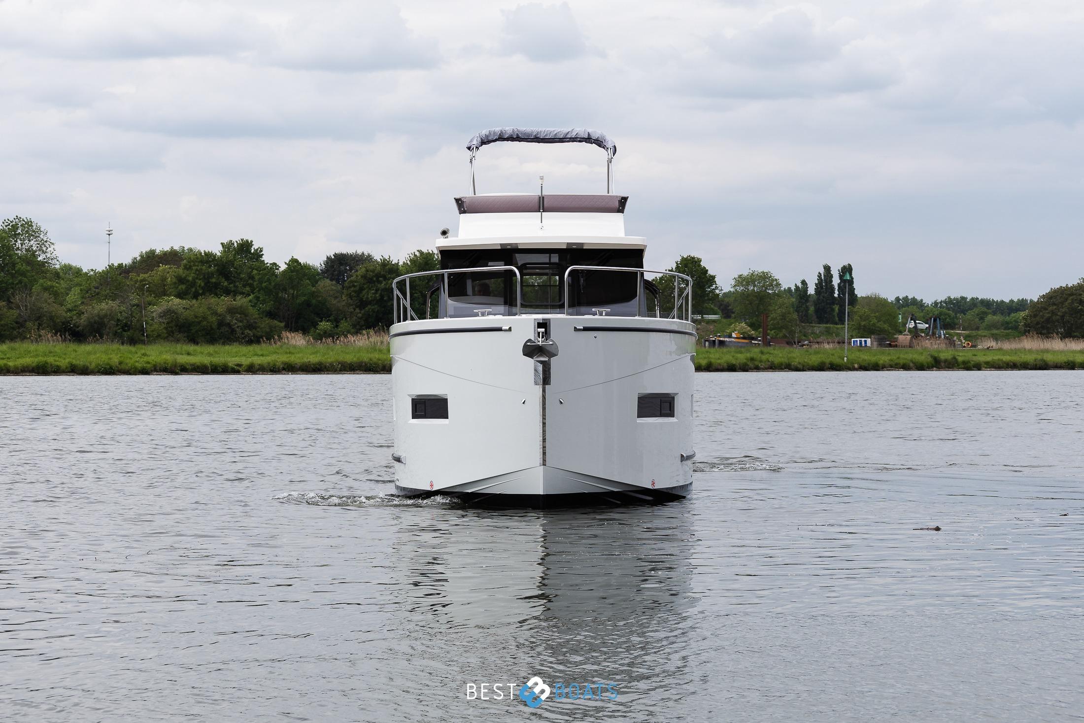 2023 Cobra Yachts Futura 36 Premium Fly cruising on a calm river.