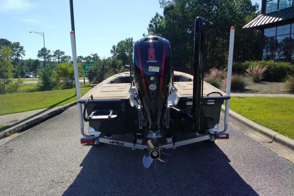 2026 Mako 18 Pro Skiff Backwater Edition boat with 150 HP engine, parked outdoors.