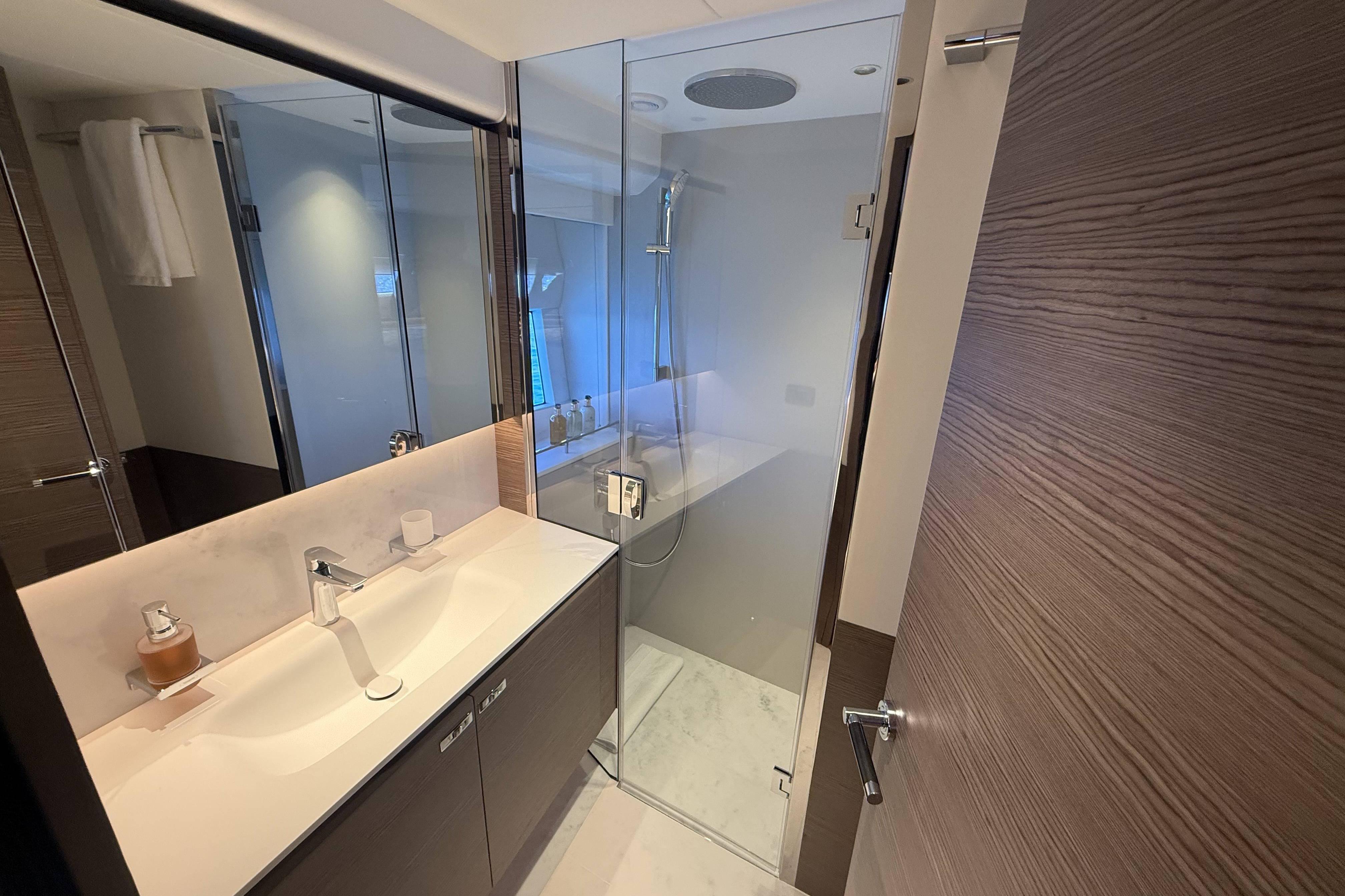 Luxurious bathroom in 2025 Princess Y72 yacht with modern fixtures and glass shower.
