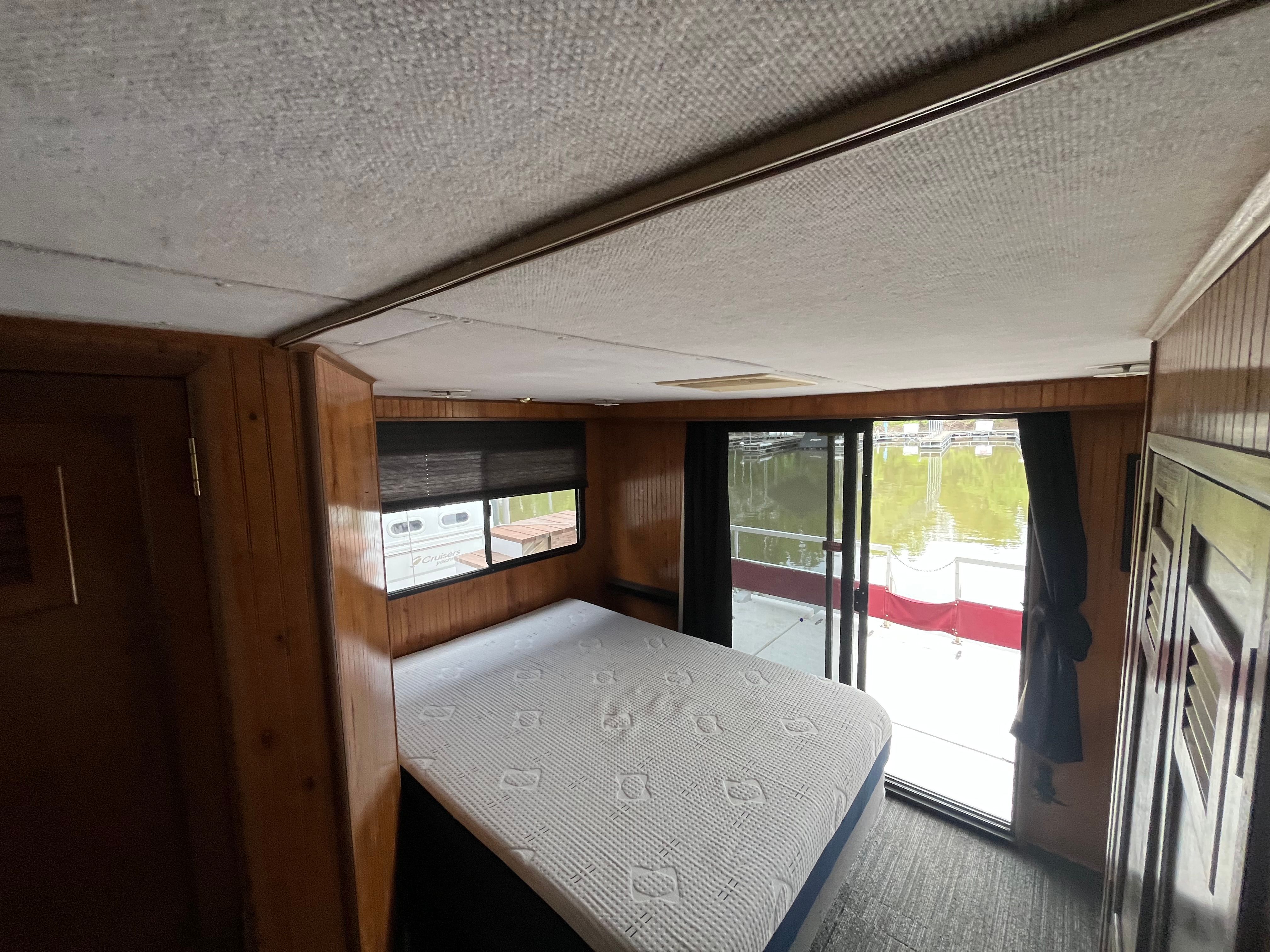 Interior of a 1995 Gibson Executive with a bed and large windows.