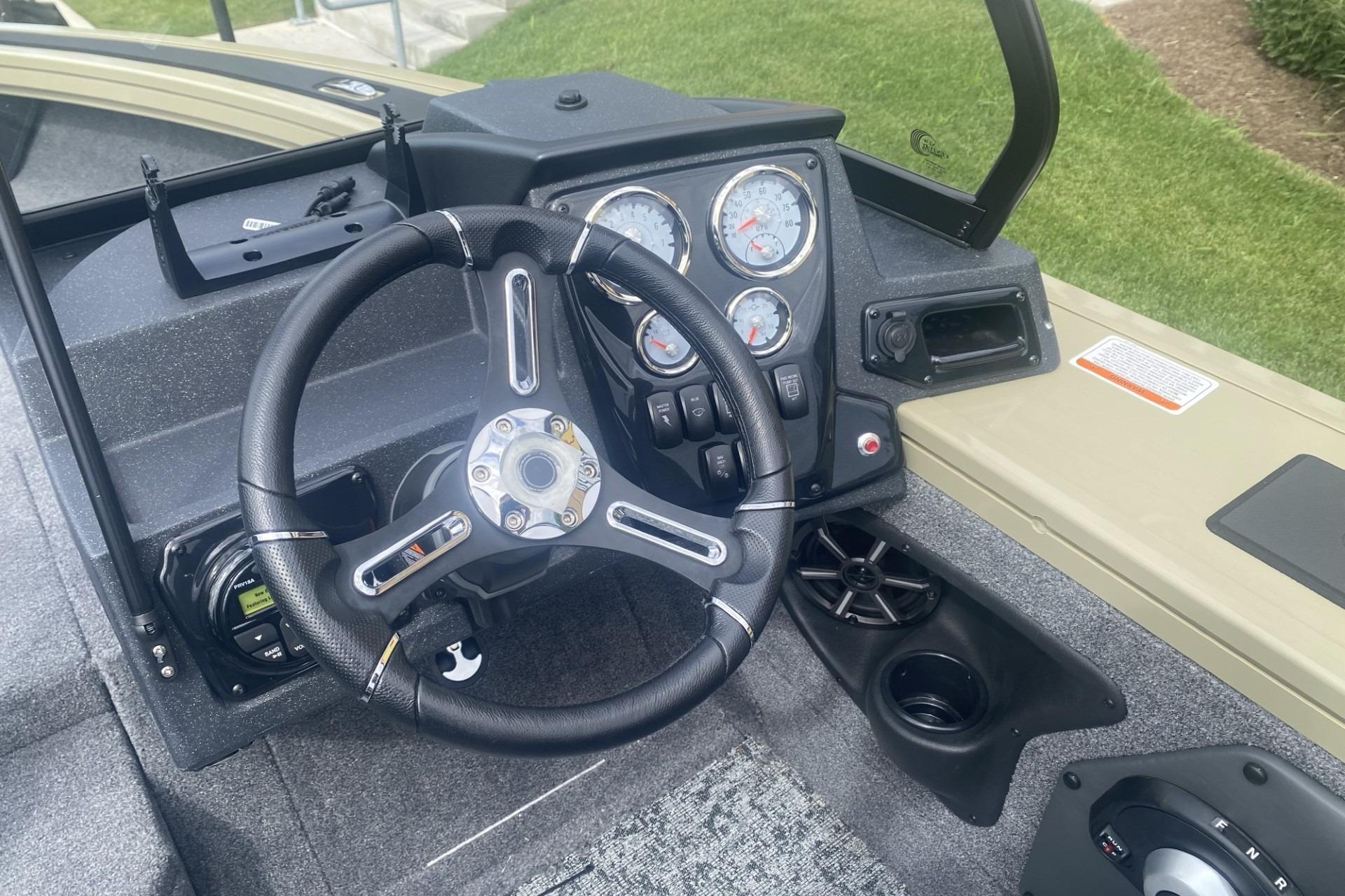 Steering console of 2026 Tracker Targa V-19 WT boat with gauges and controls.