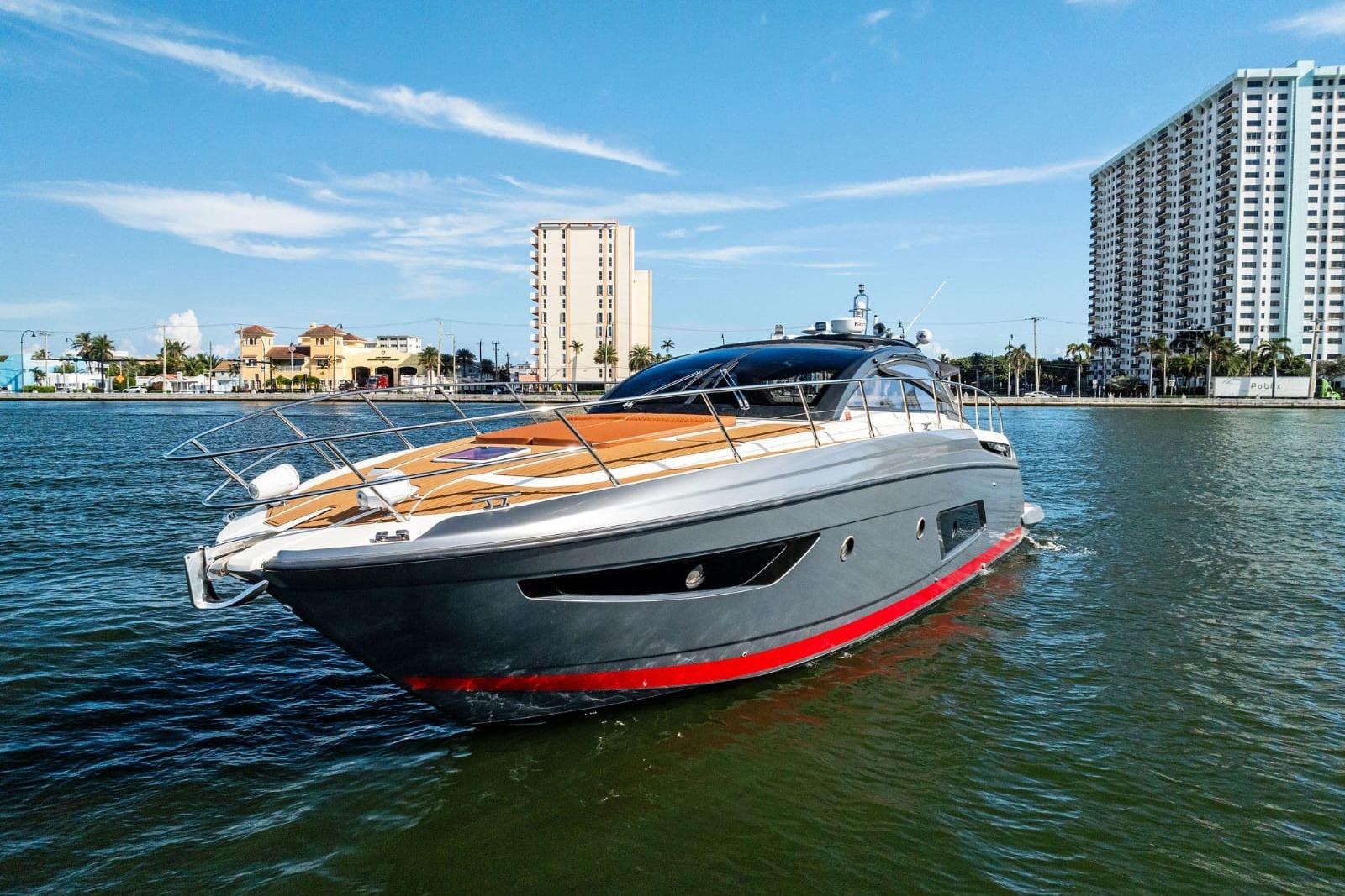 Azimut Atlantis 48 yacht, 2013 model, cruising in a sunny urban waterfront setting.