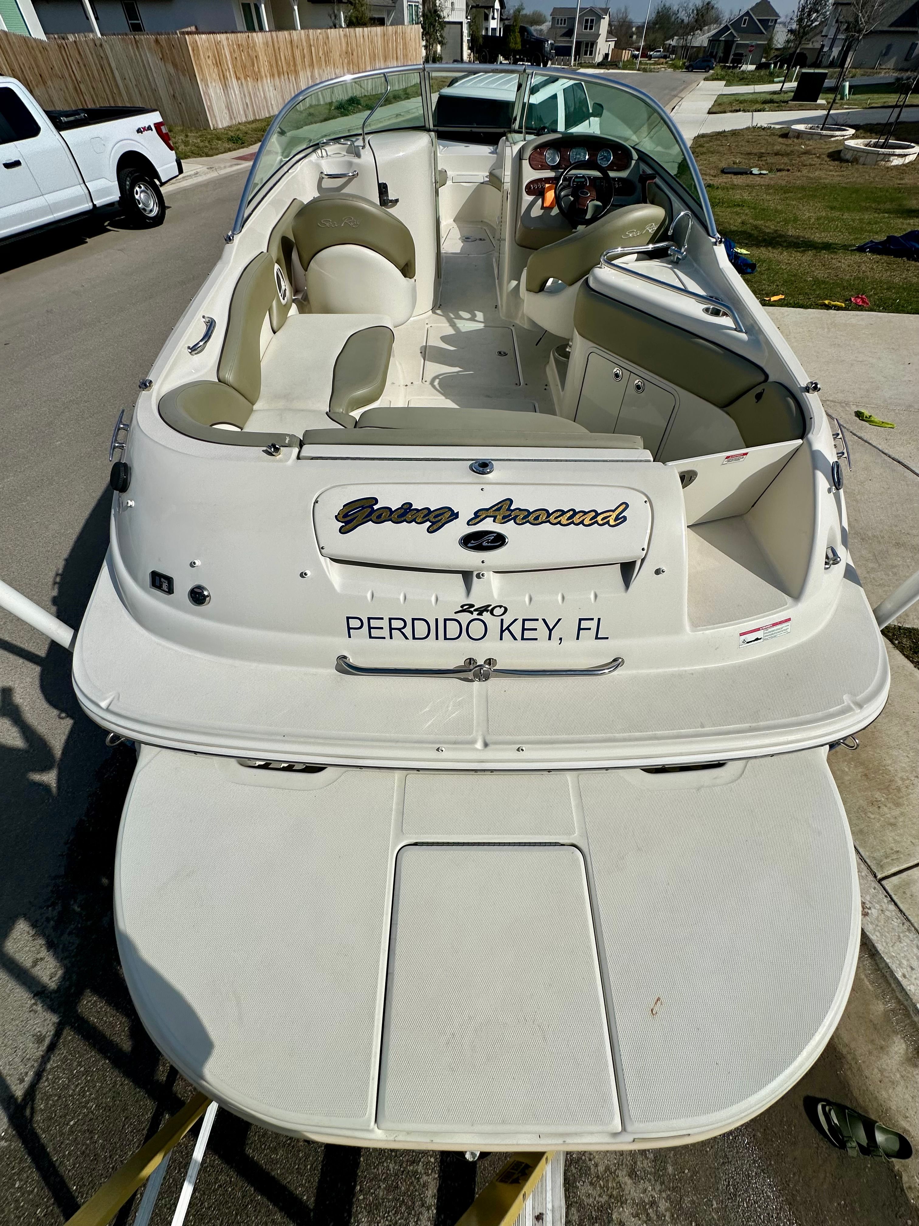 2006 Sea Ray 240 Sundeck boat parked in a residential area.