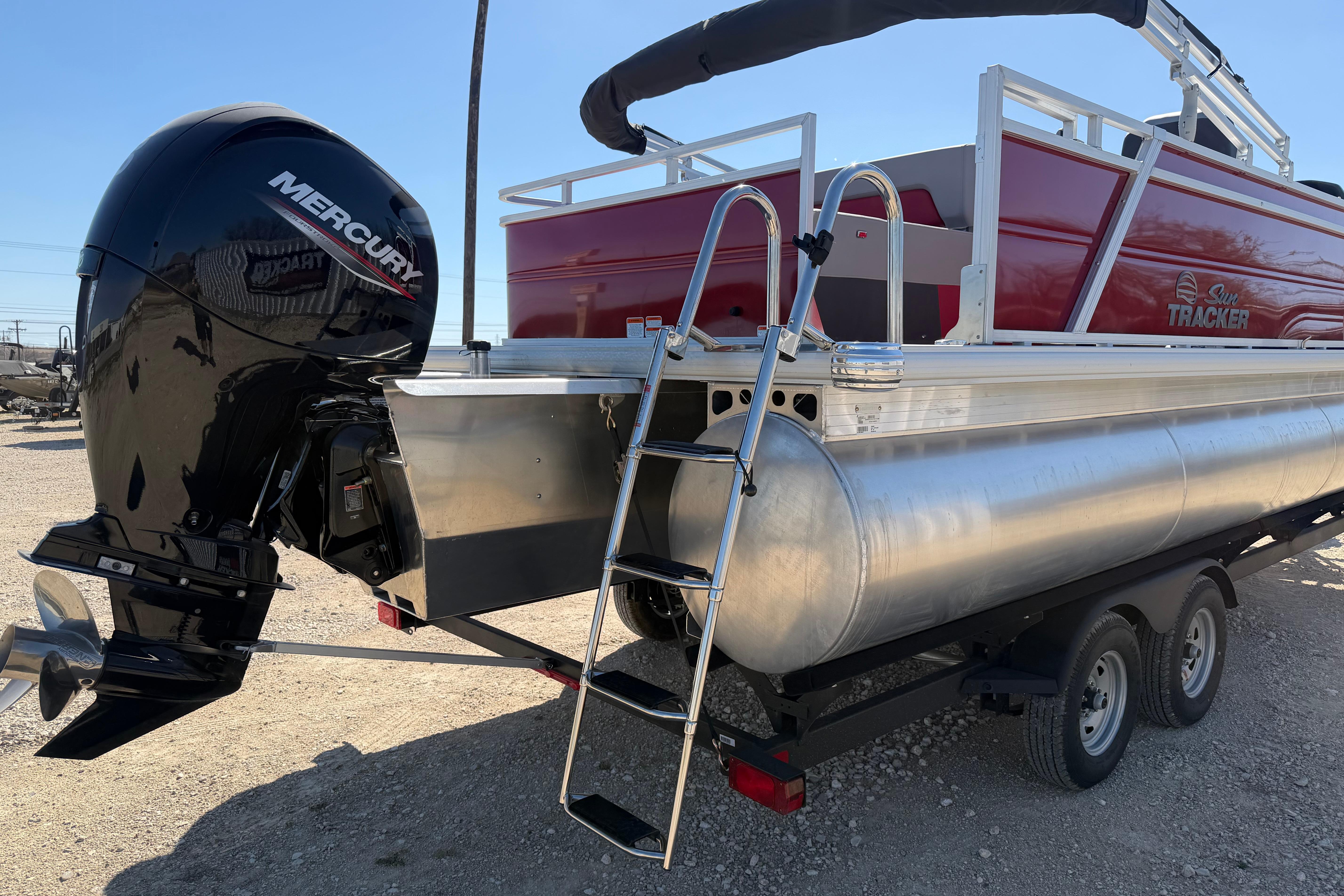 2026 Sun Tracker Party Barge 22 RF XP3 with Mercury engine and ladder, on trailer.
