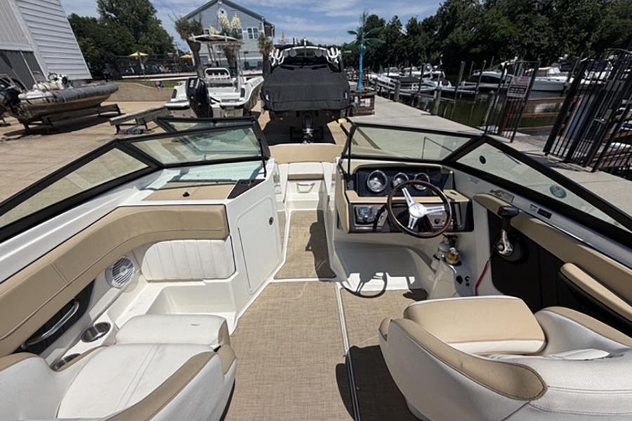 Interior view of a 2018 Sea Ray SPX 190 boat at a marina.