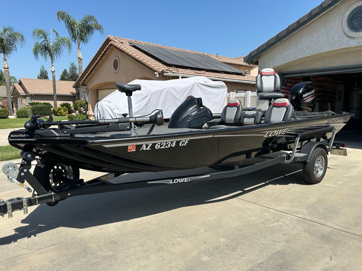 2018 Lowe Stinger 175C on a trailer in a driveway.