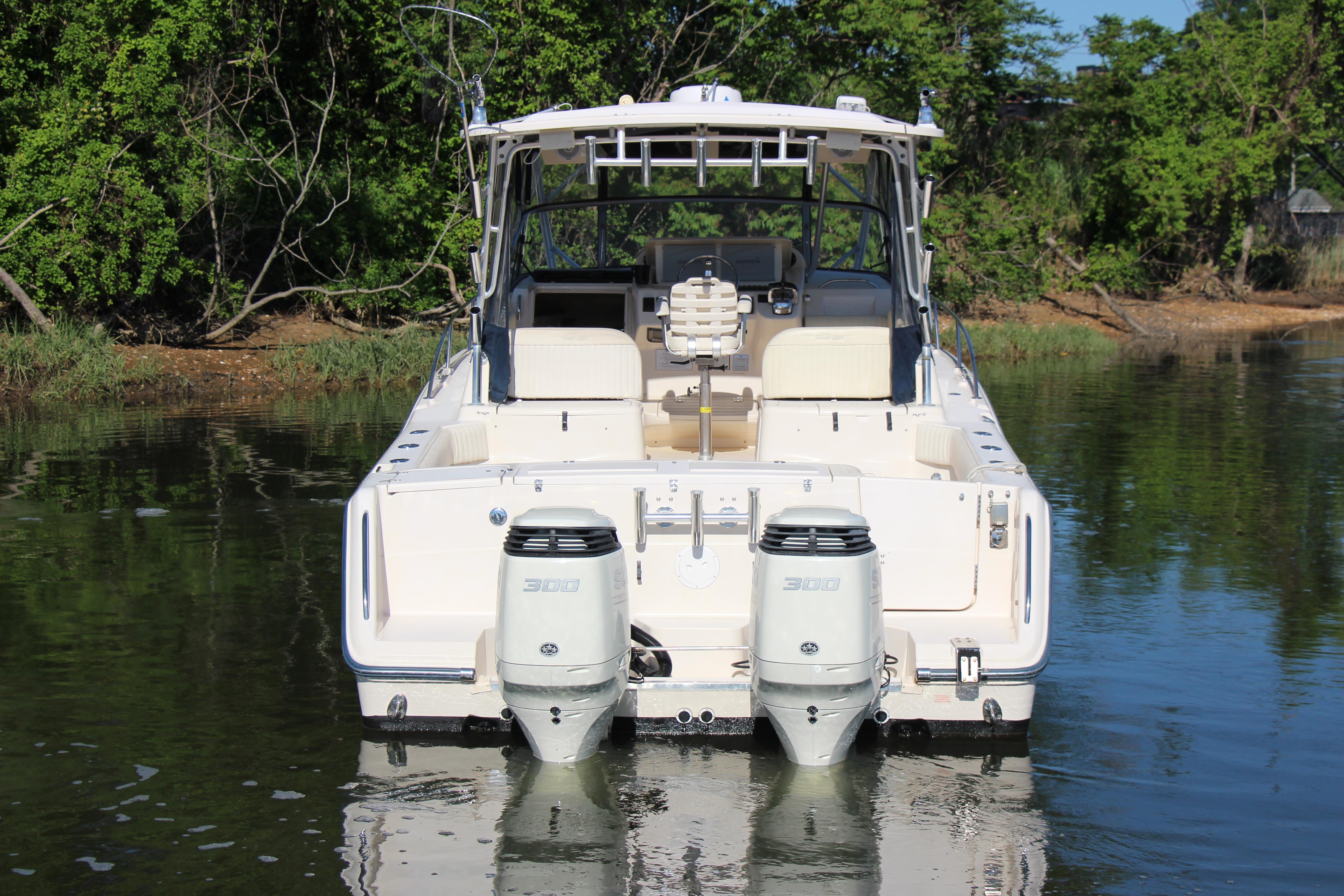 2005 Grady-White Express 330 boat with dual engines on calm water.