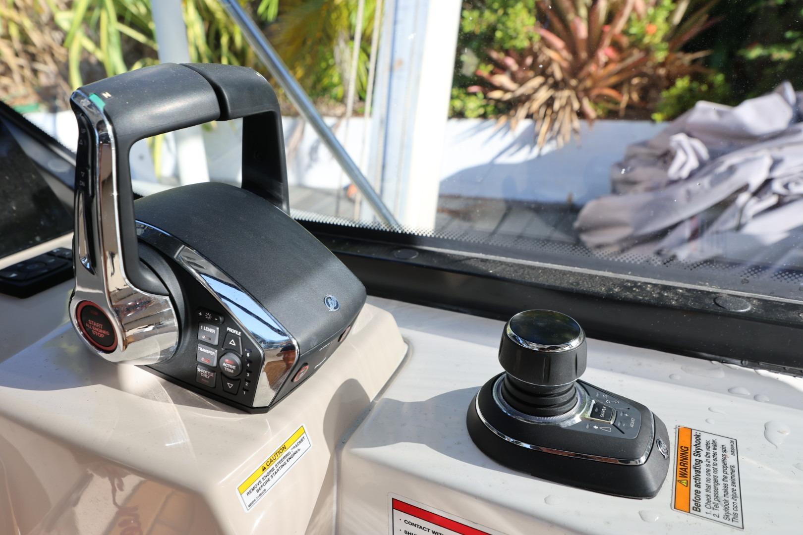 Control panel of 2025 Boston Whaler 325 Conquest boat with joystick and throttle.