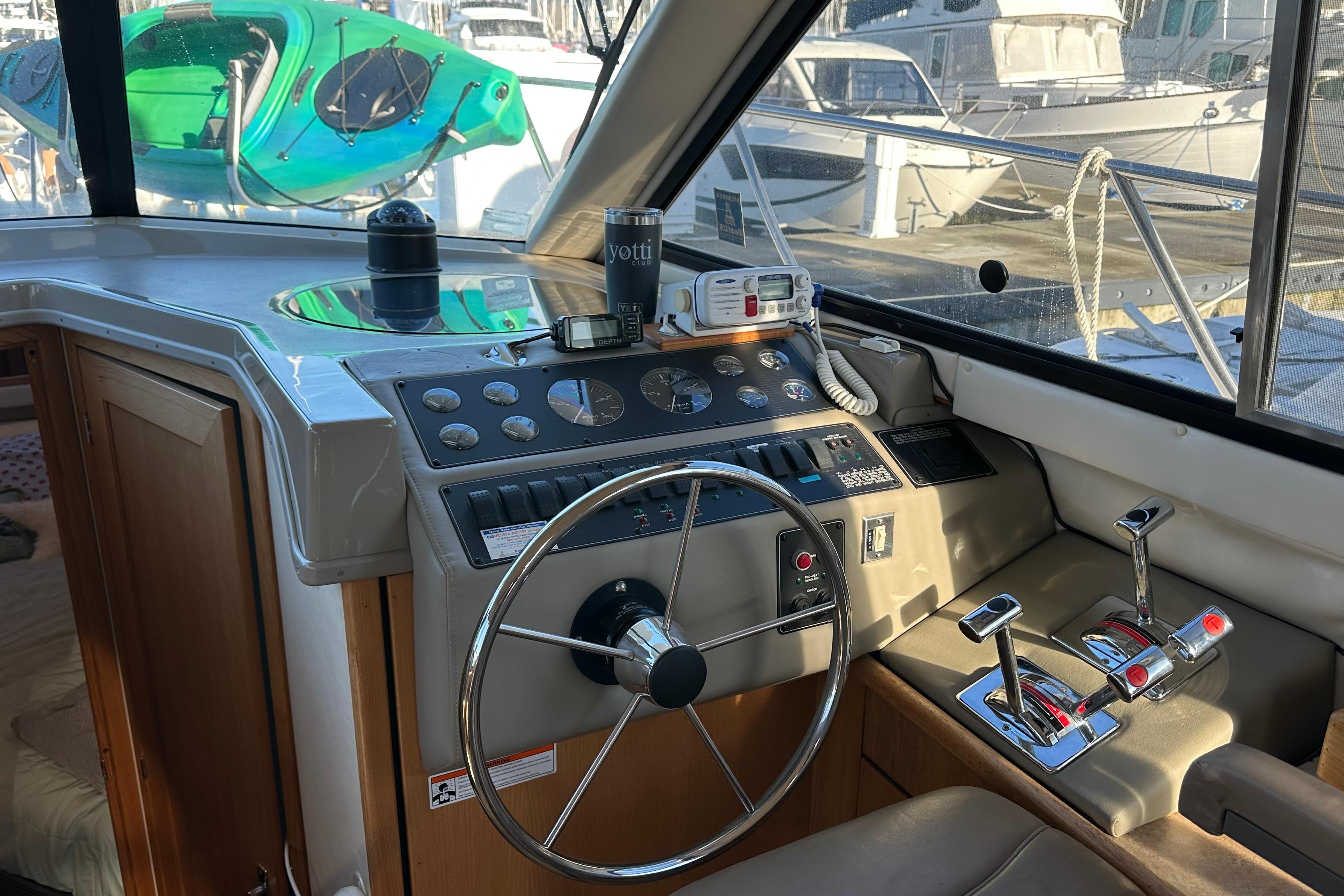 Cockpit of 2000 Bayliner 4087 Aft Cabin Motoryacht with steering wheel and control panel.
