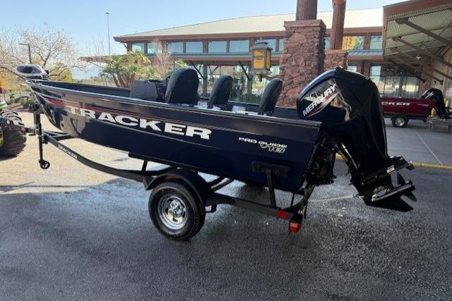 2026 Tracker Pro Guide V-16 SC boat on trailer, outdoor setting.