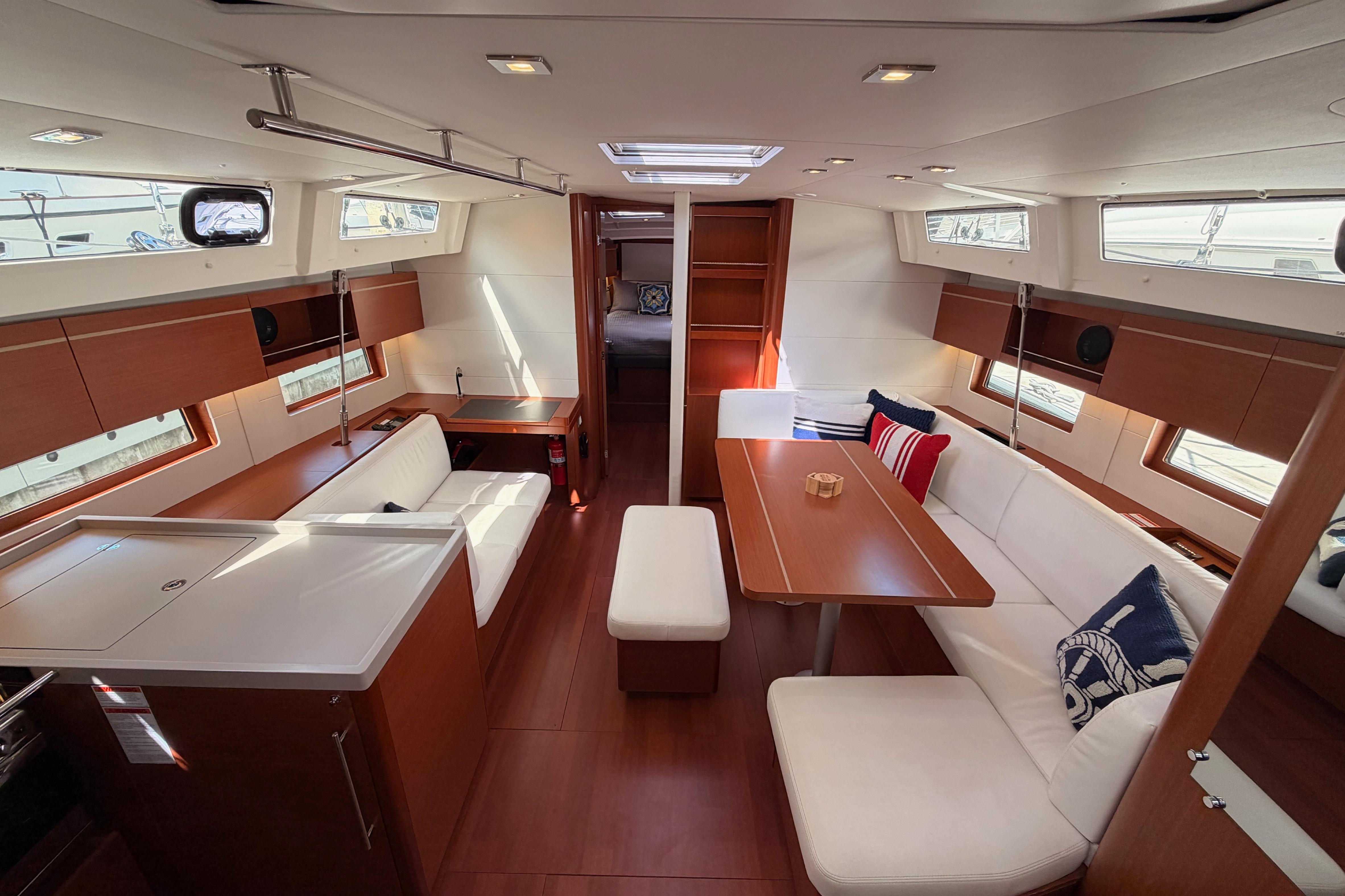 Luxurious interior of 2020 Beneteau Oceanis 46.1 yacht with elegant seating and dining area.