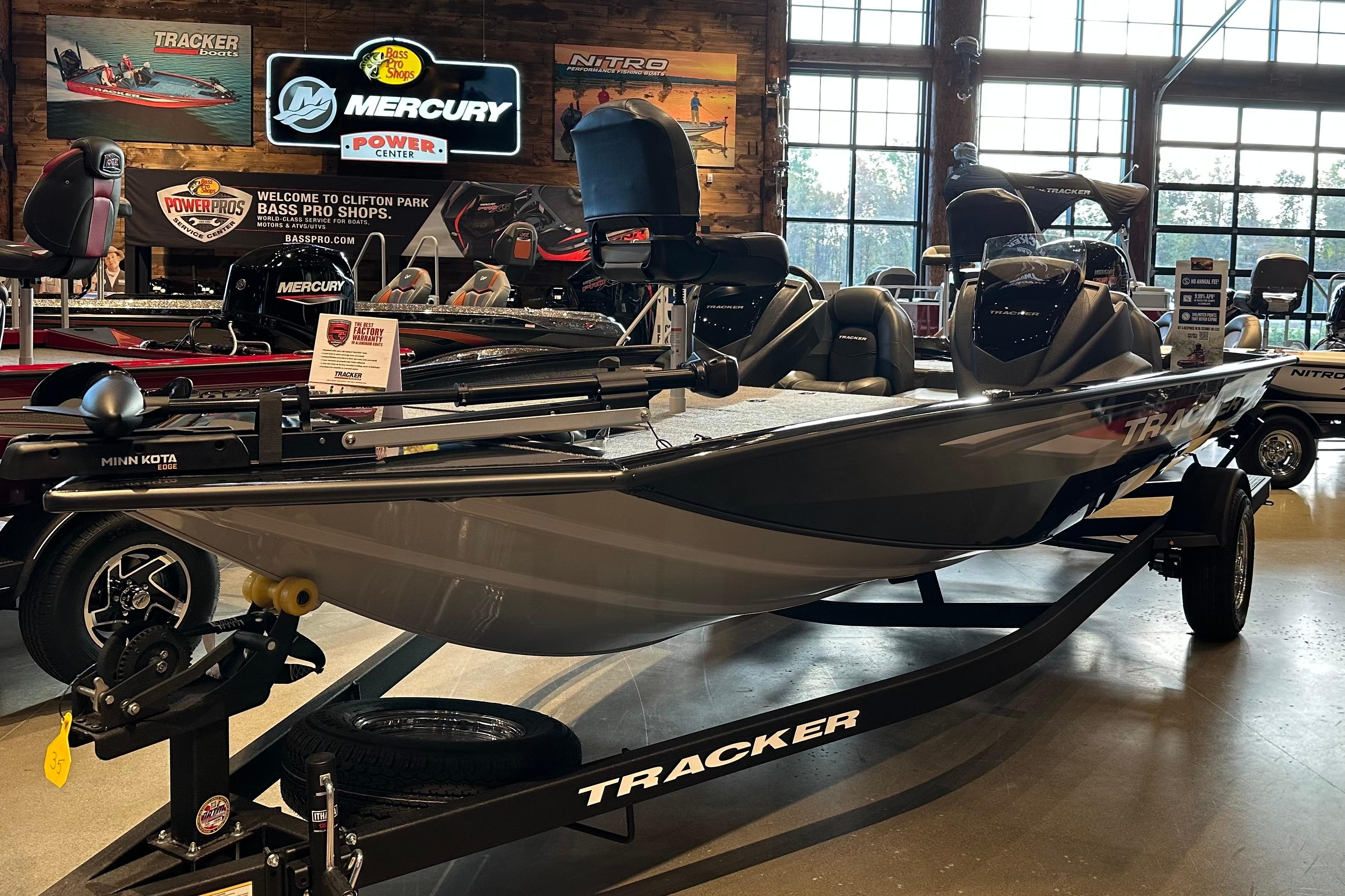 2026 Tracker Pro Team 195 boat displayed at Bass Pro Shops showroom.