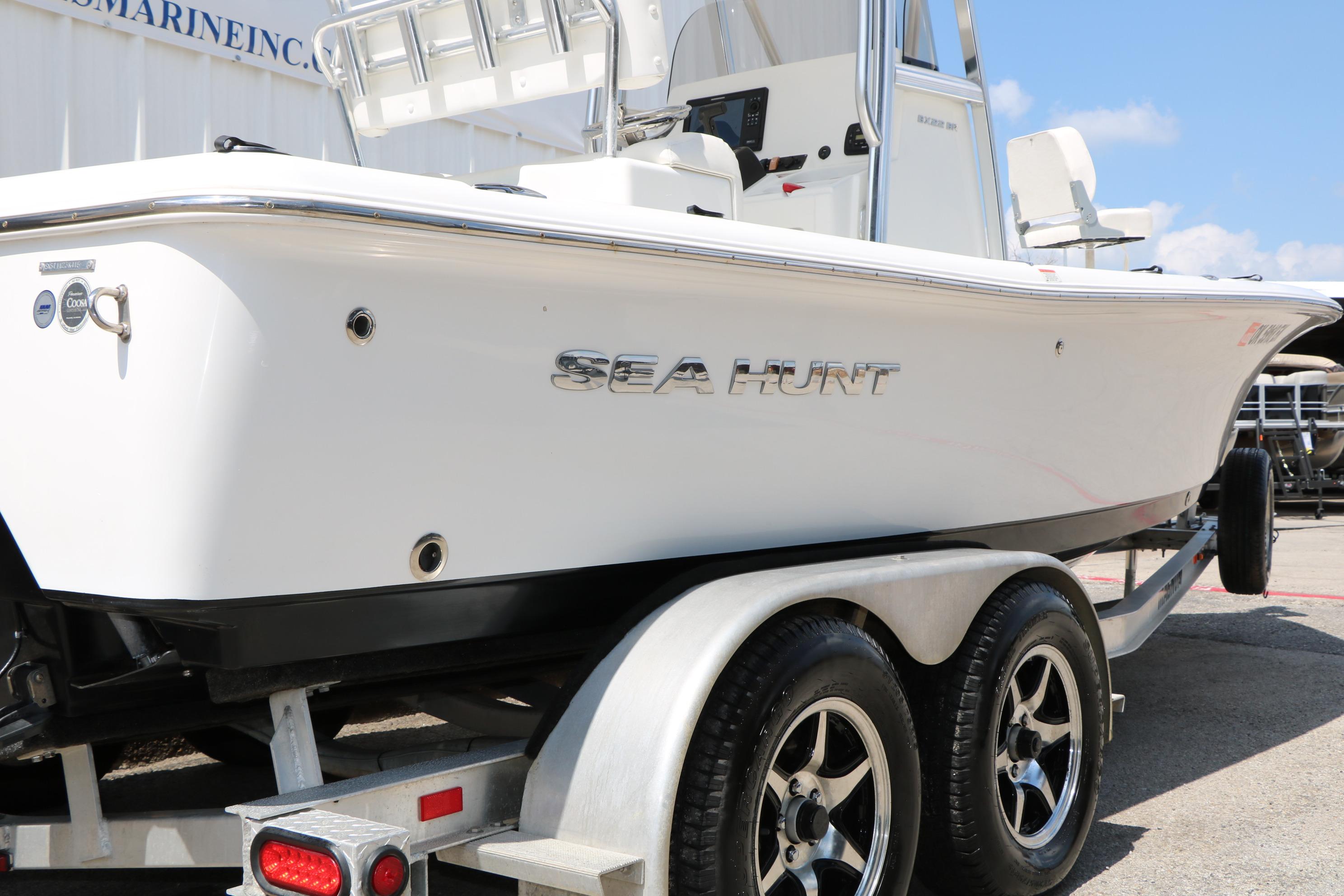 2015 Sea Hunt BX 22 BR boat on trailer, side view, white hull, sunny day.