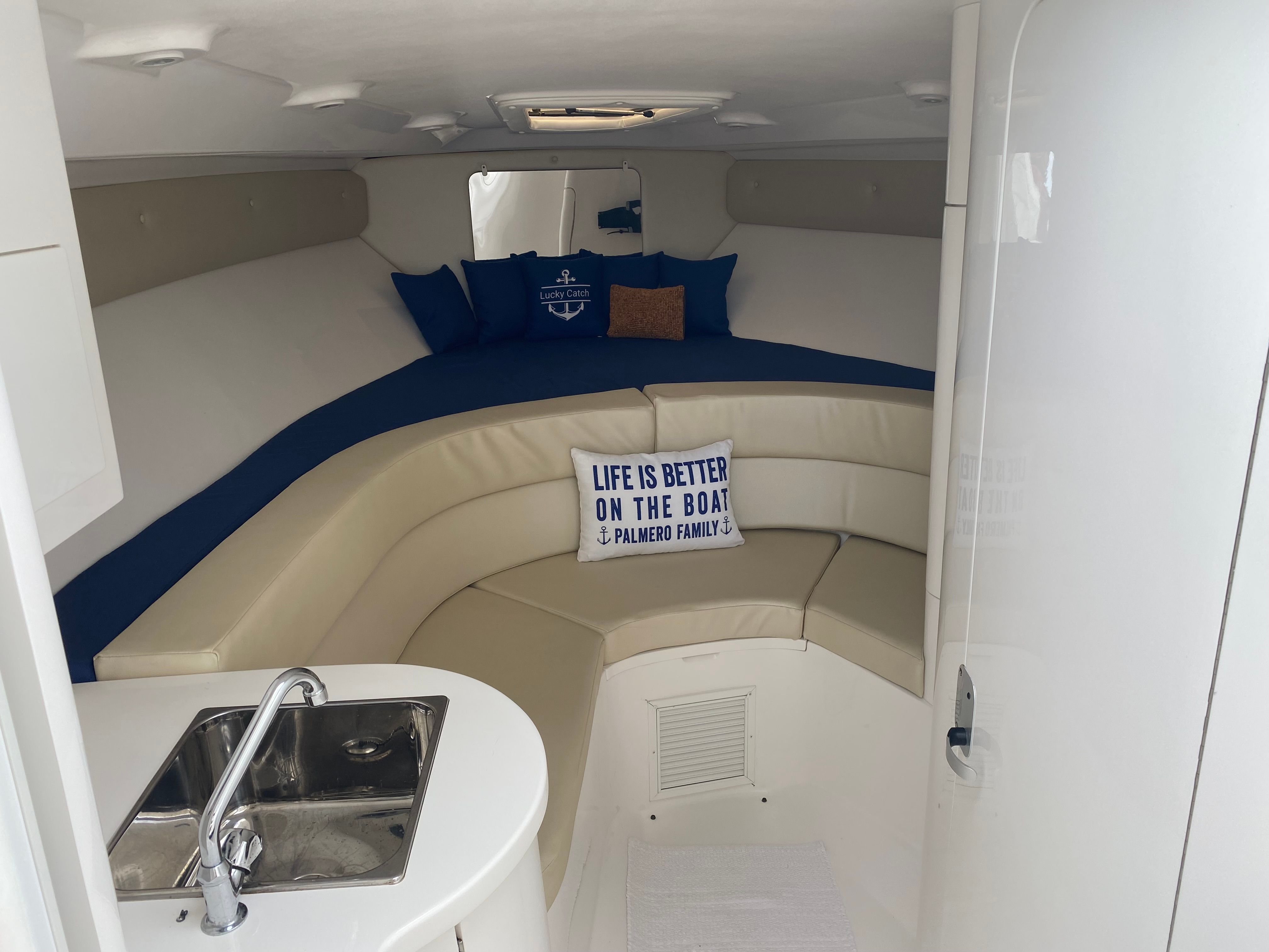 Interior of a 2011 Intrepid 37 with cozy seating area and sink.