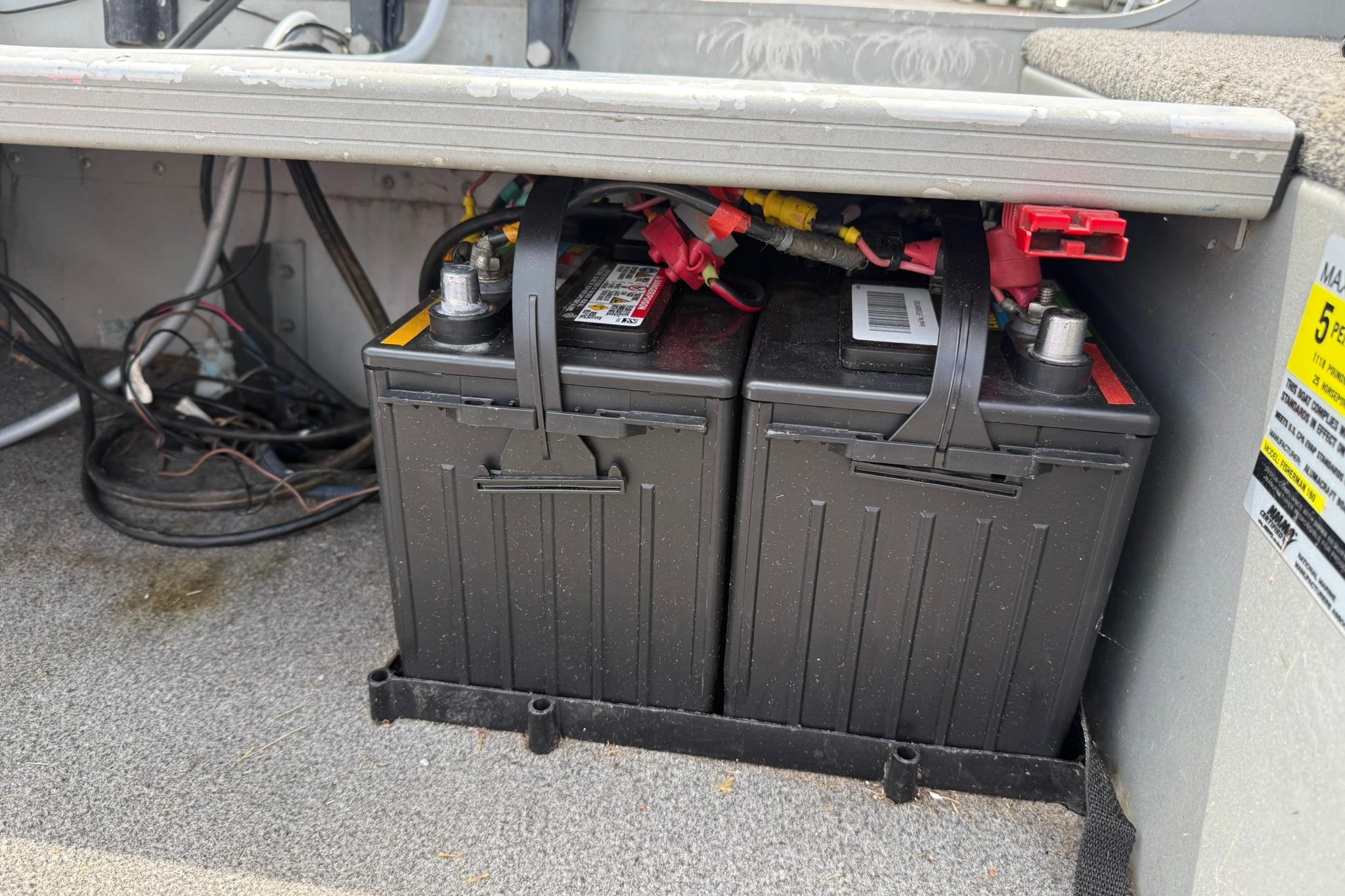 Two marine batteries installed in a 2013 Alumacraft Fisherman 160 Tiller boat.