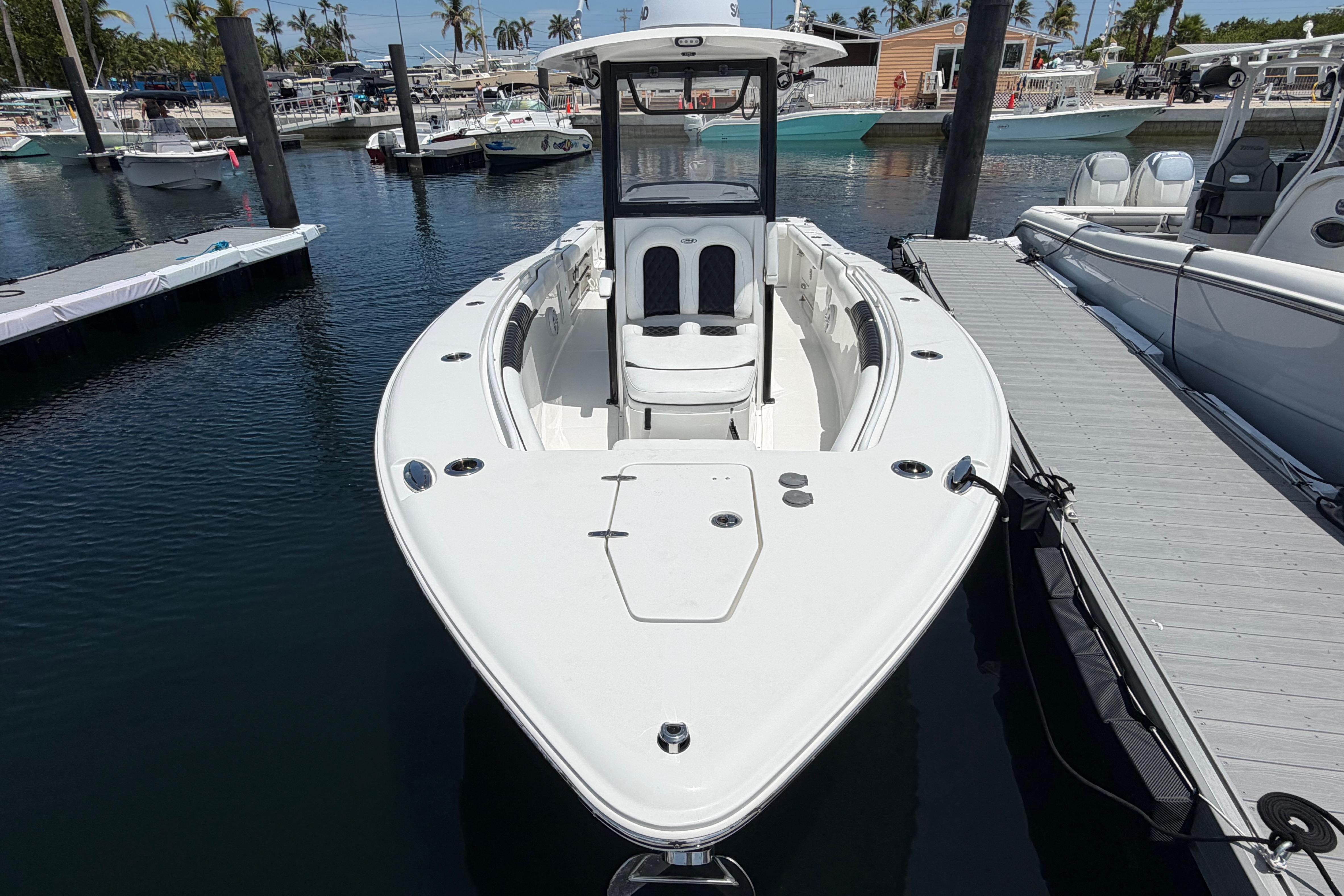 2019 Sea Hunt Gamefish 27 Coffin Box boat docked in a marina.