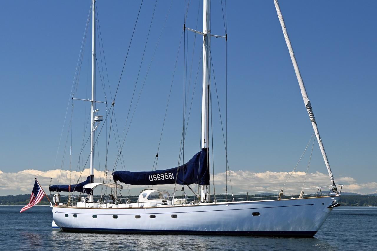 Vintage 1968 Abeking & Rasmussen Tripp 74 yacht sailing on calm waters under clear skies.
