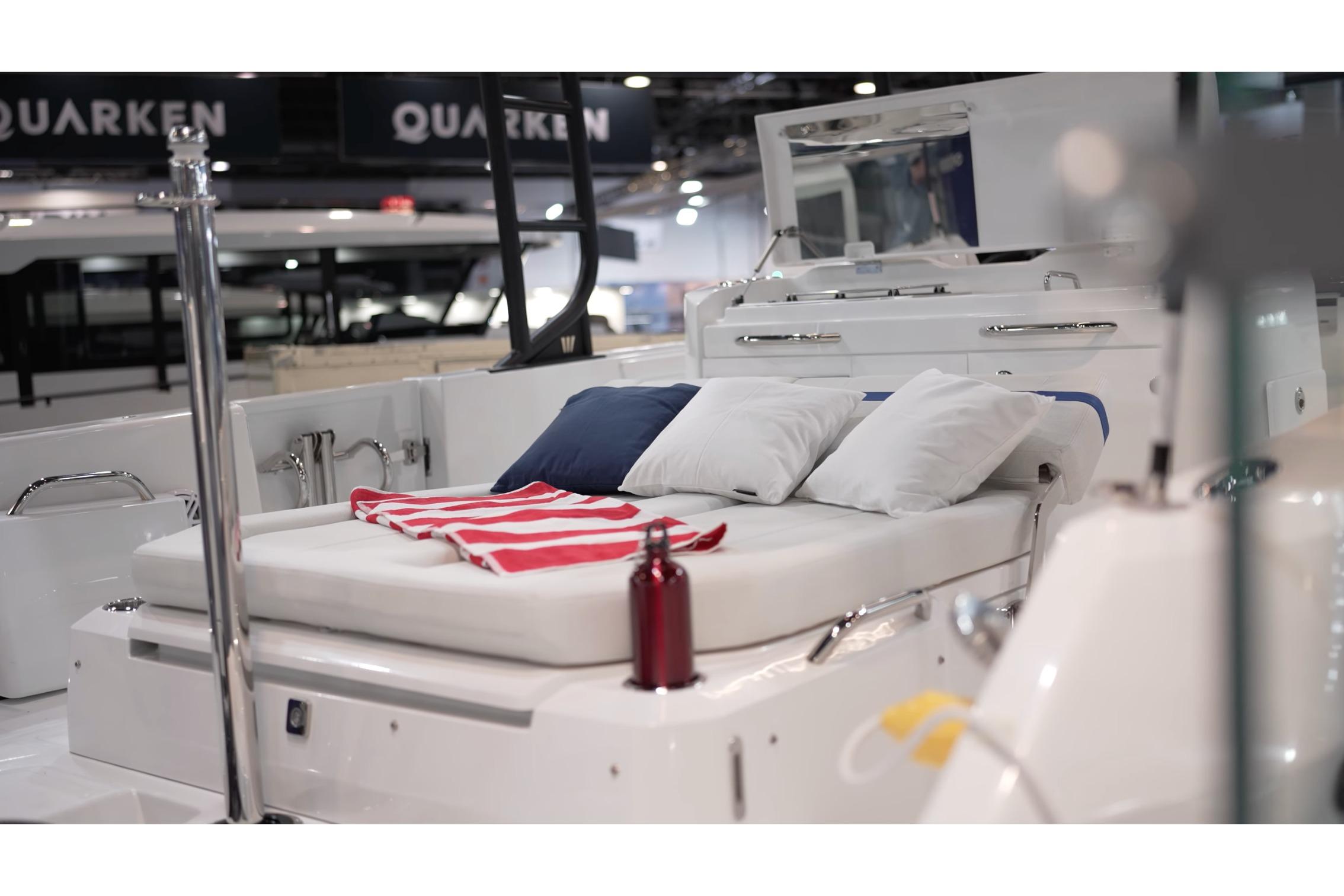 2026 Wellcraft 28 T-Top boat interior with cushioned seating and nautical decor.