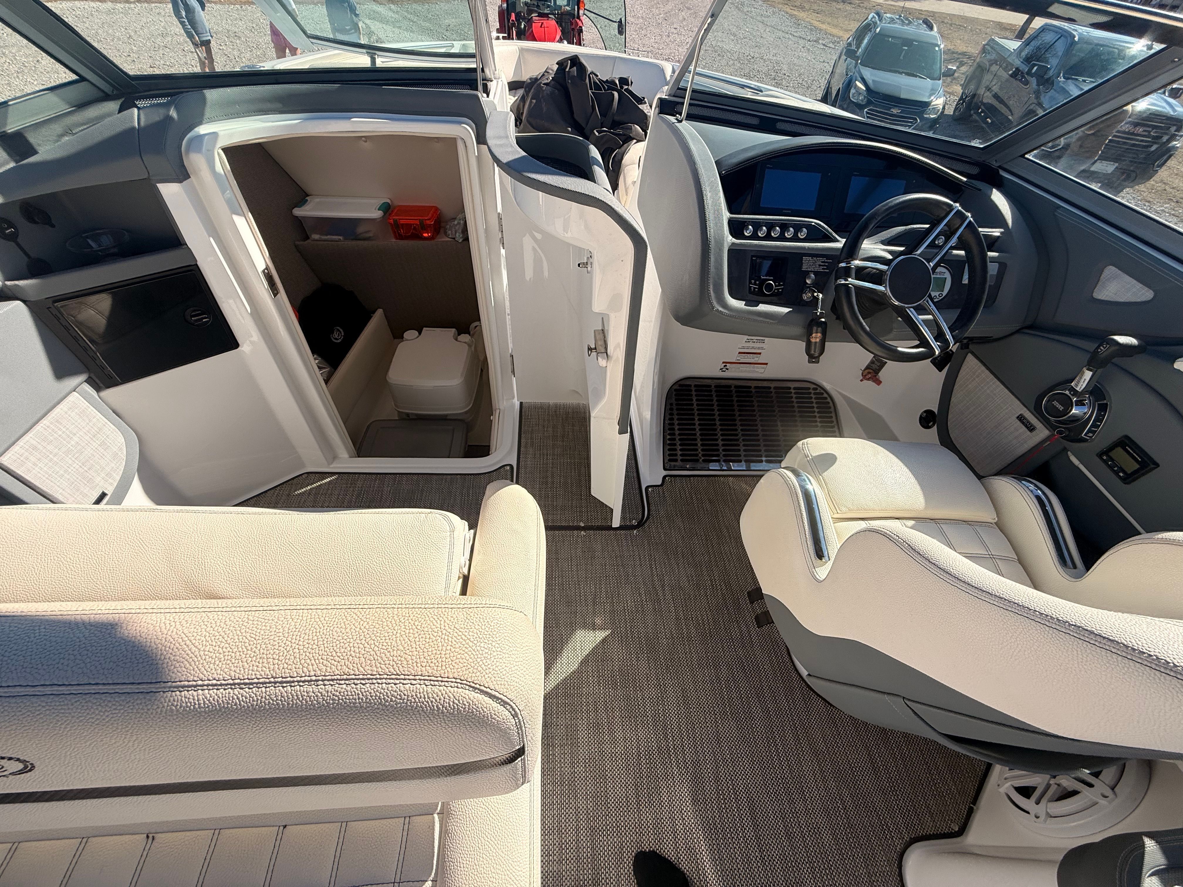 The image shows the cockpit of a 2019 Cobalt R7 Surf boat with modern instruments and comfortable seating.