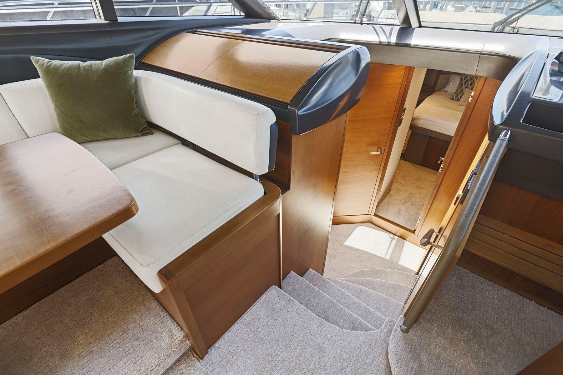 Interior of 2015 Princess 60 Flybridge Motor Yacht with elegant seating and cabin access.