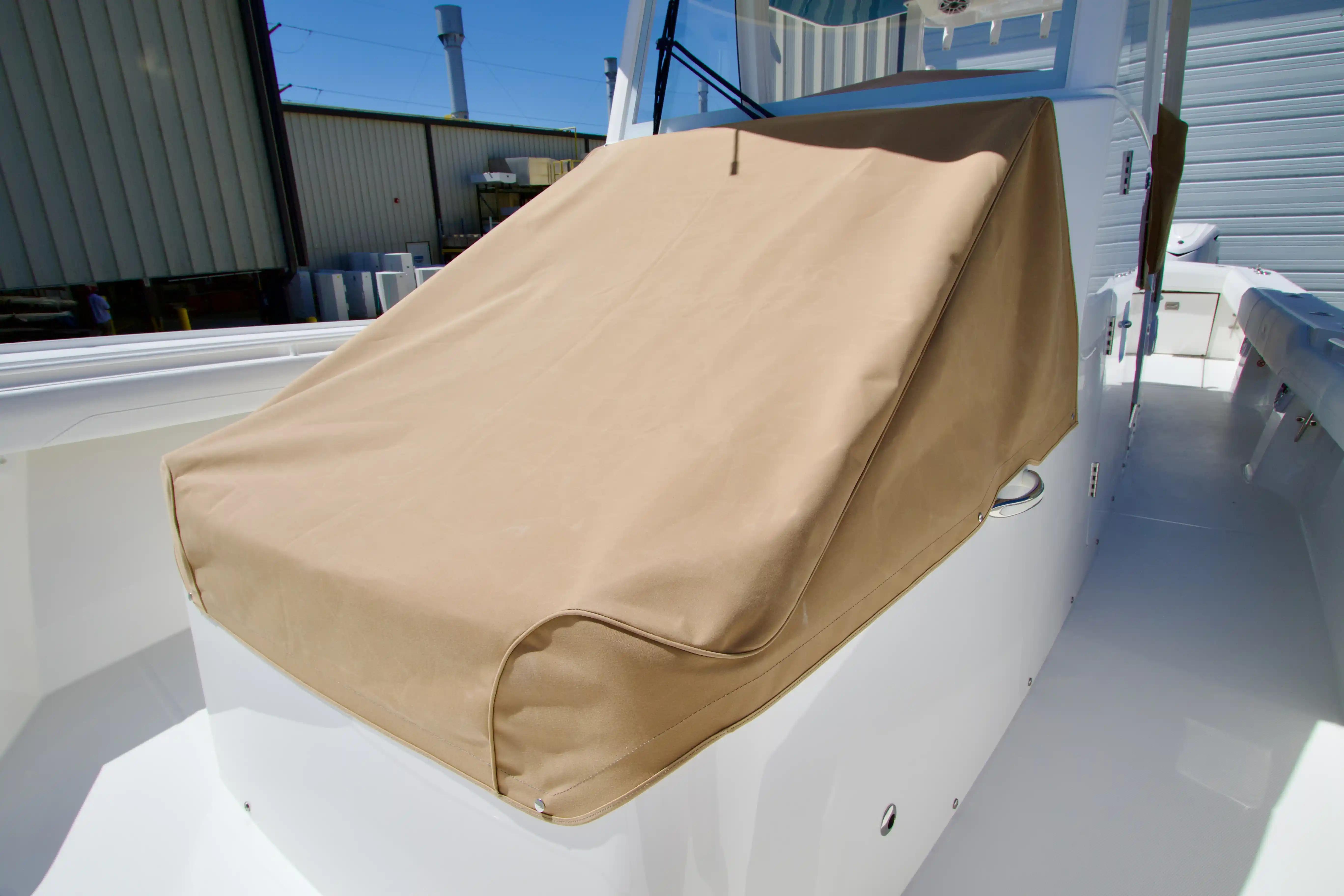2027 Regulator 35 boat with tan cover, docked outdoors.