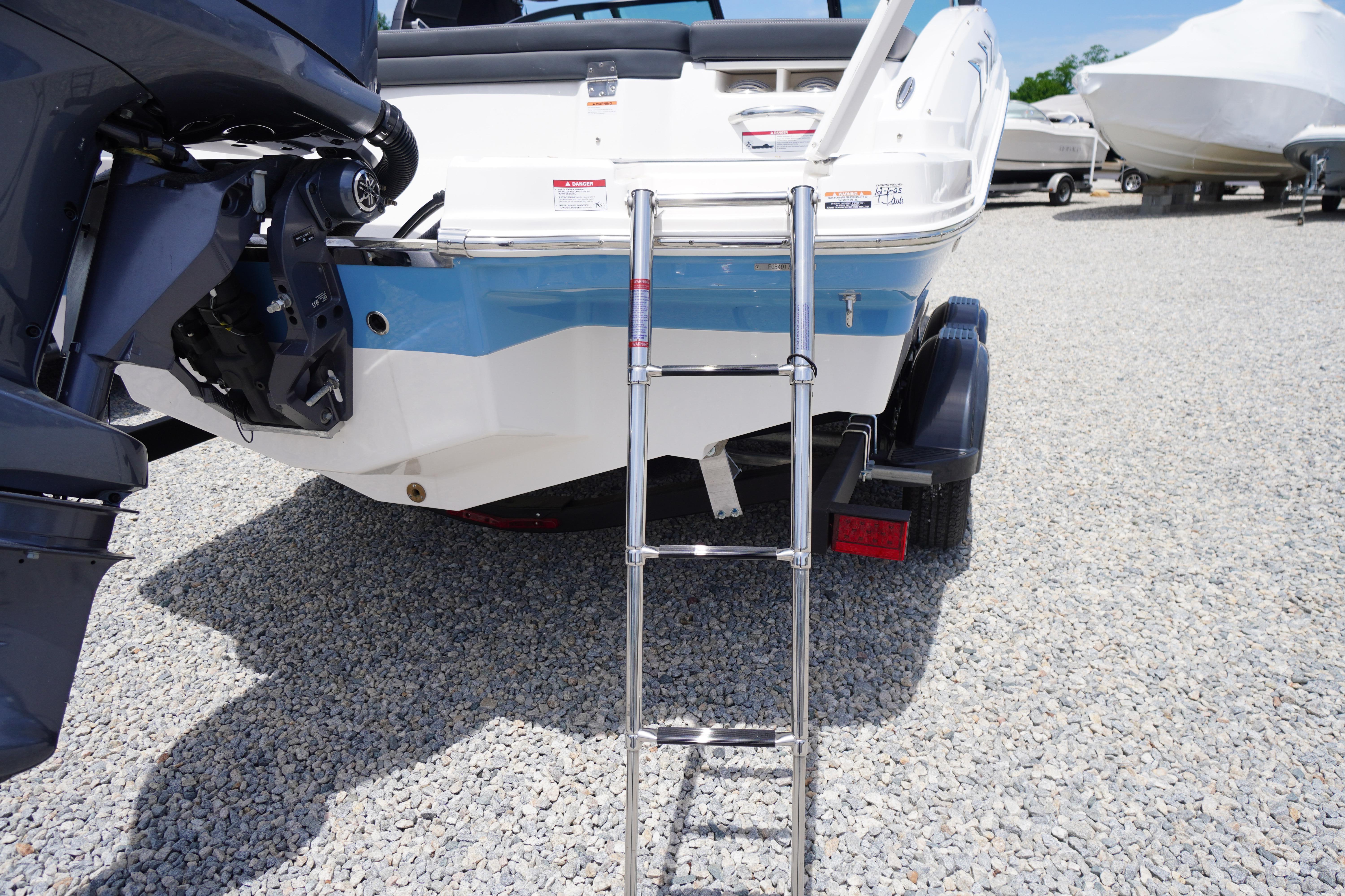 2026 Chaparral 23 SSi OB boat rear view with ladder and outboard motor.