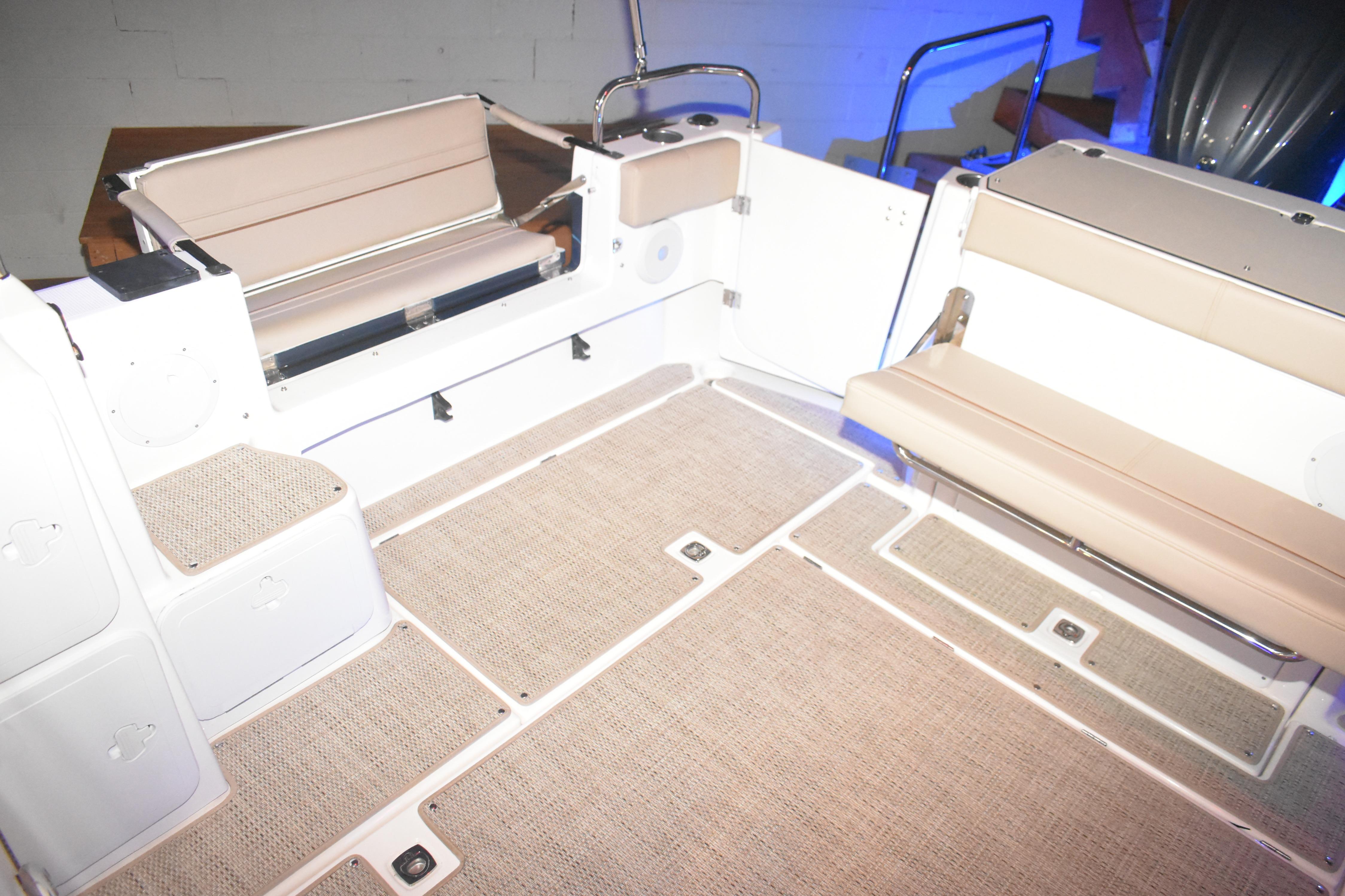 2026 Cutwater C-32 CB boat interior with beige seating and carpeted flooring.