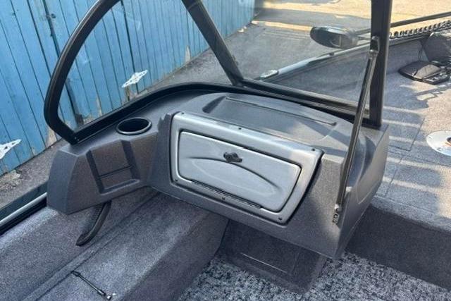 2026 Tracker Pro Guide V-16 WT boat interior with storage compartment and cup holder.