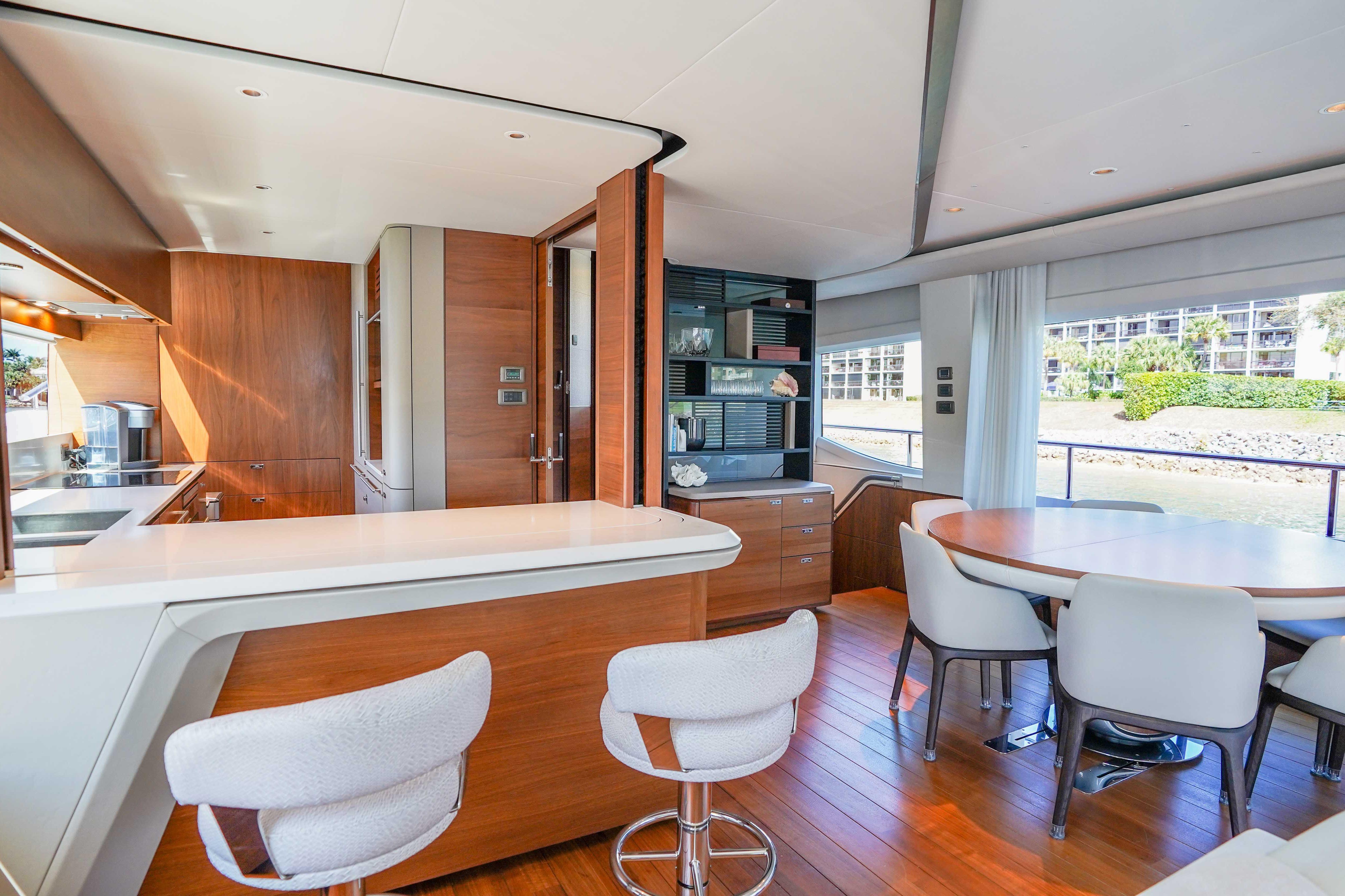 Luxurious interior of 2021 Princess Y85 yacht with modern kitchen and dining area.