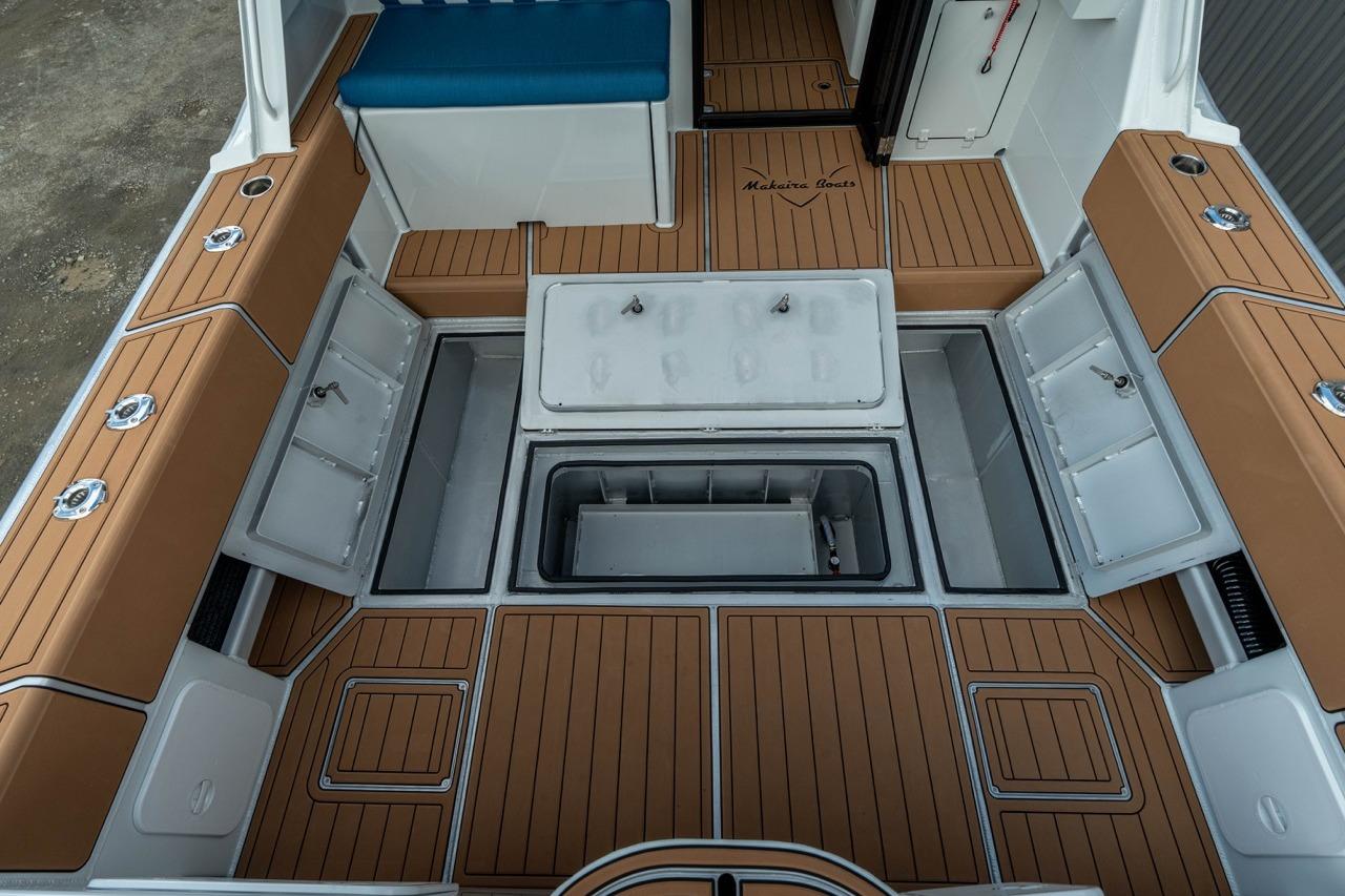 2025 Makaira Gen 3 36 boat interior with storage compartments and teak flooring.