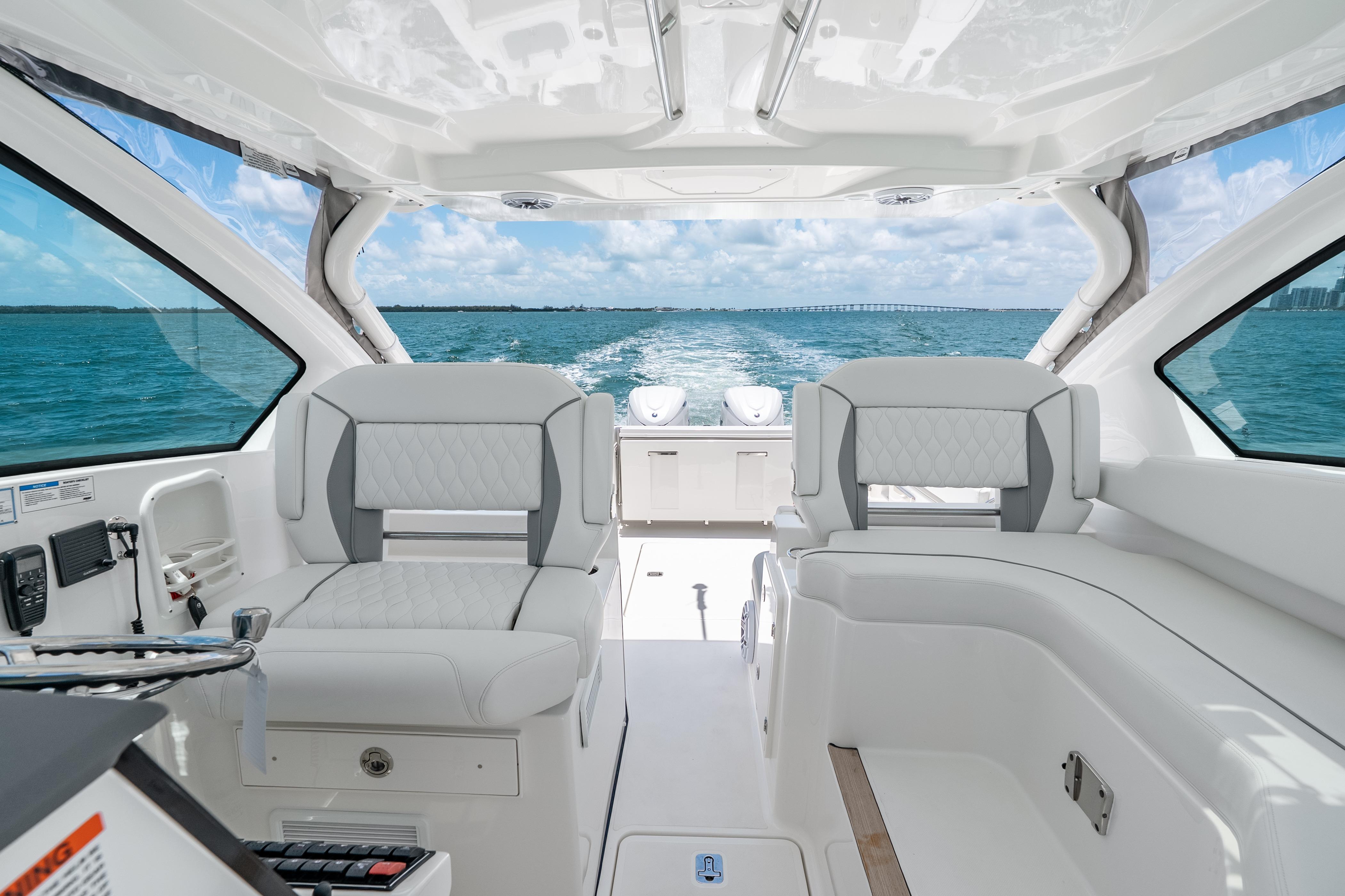 2026 Pursuit DC 326 Dual Console interior with ocean view, featuring luxurious seating.