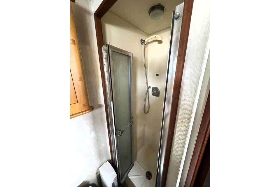 Shower area inside a 1980 Viking 43 Convertible boat, featuring a compact design.
