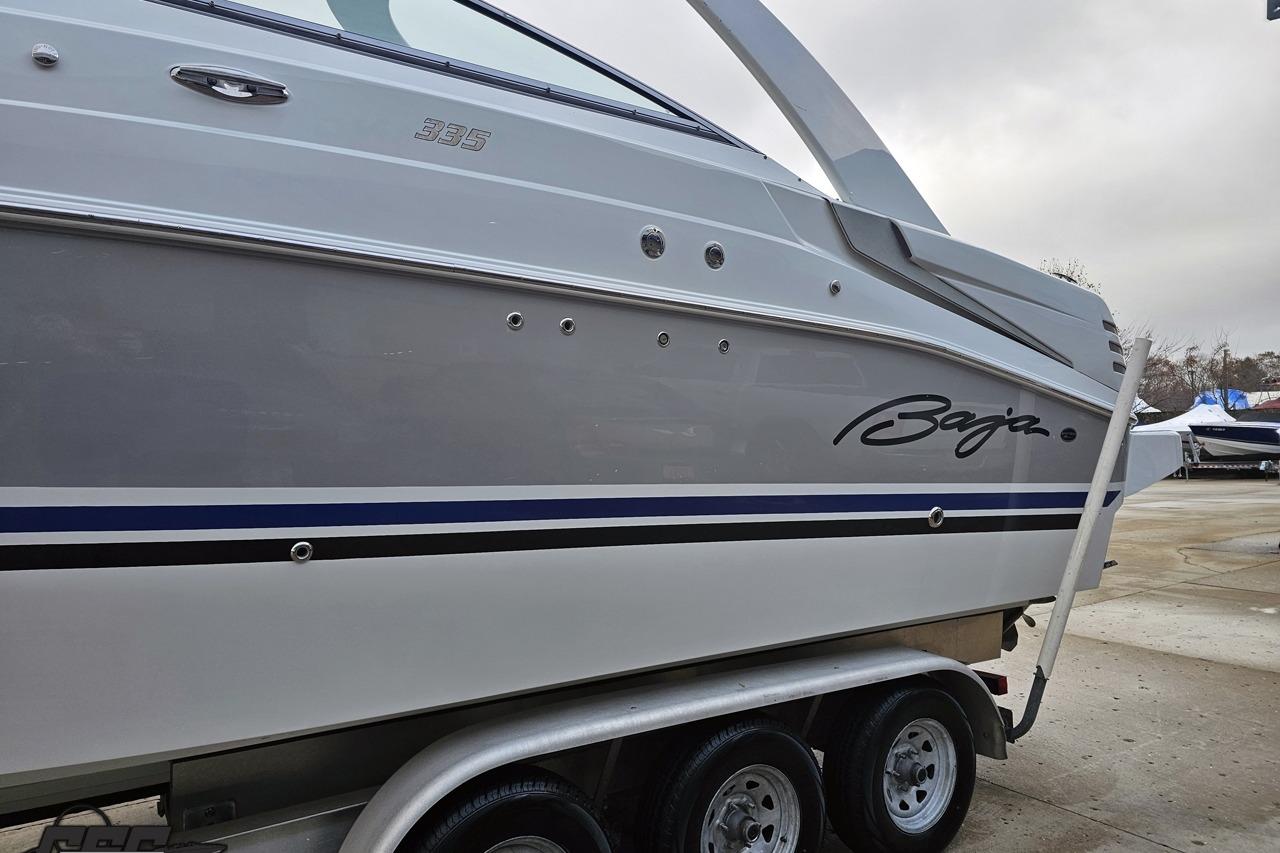 2008 Baja 335 Performance boat on trailer, featuring sleek design and modern graphics.