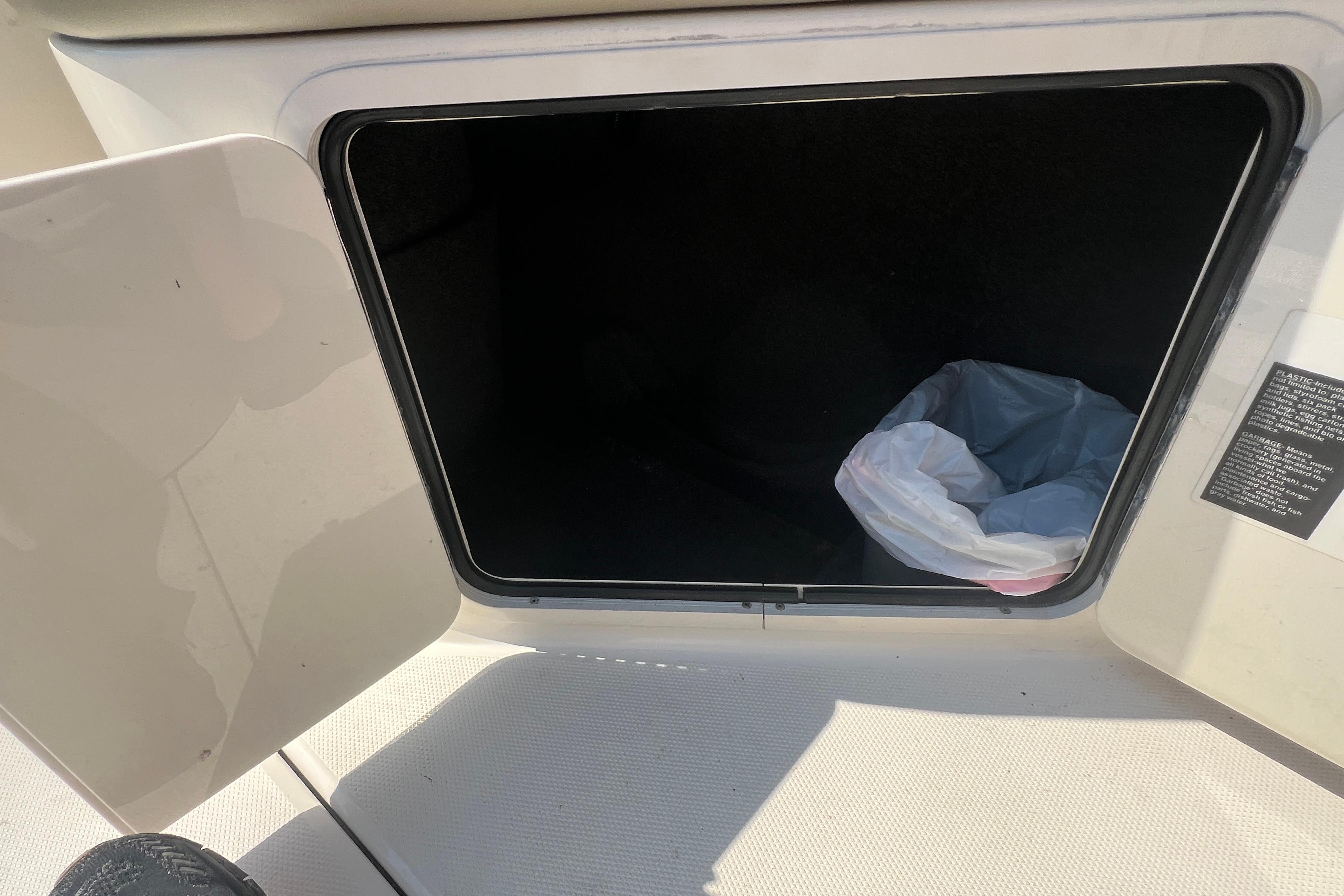 Open storage compartment on a 2005 Sea Ray 240 Sundeck boat.