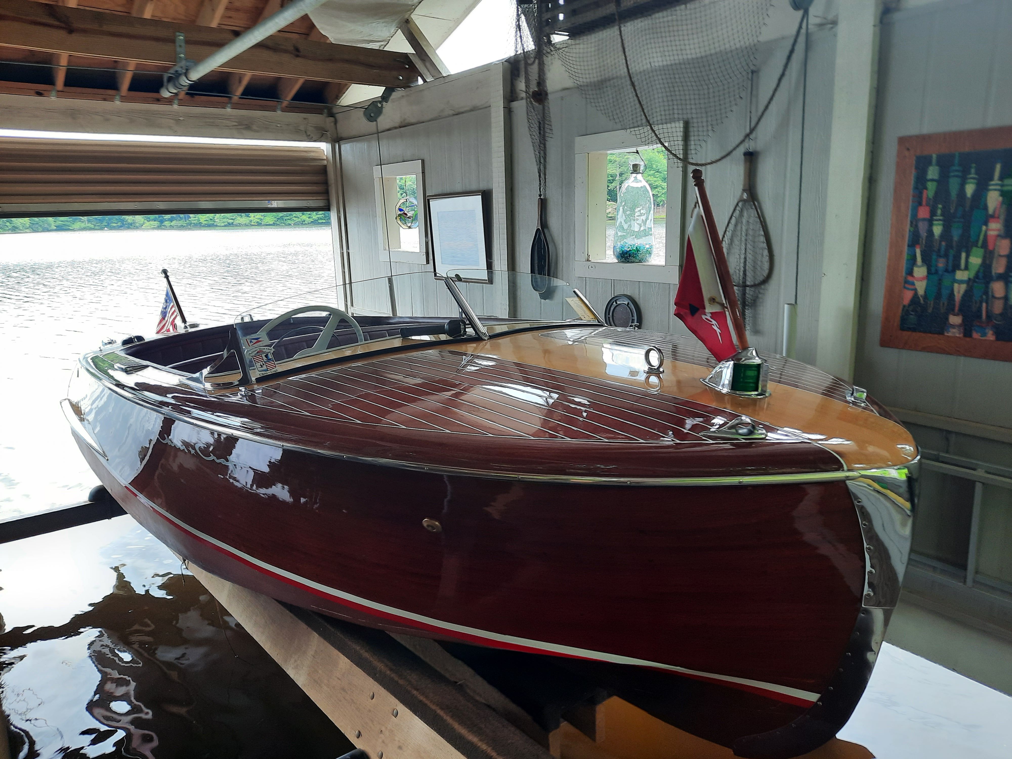 1954 Chris-Craft Riviera boat in a boathouse.