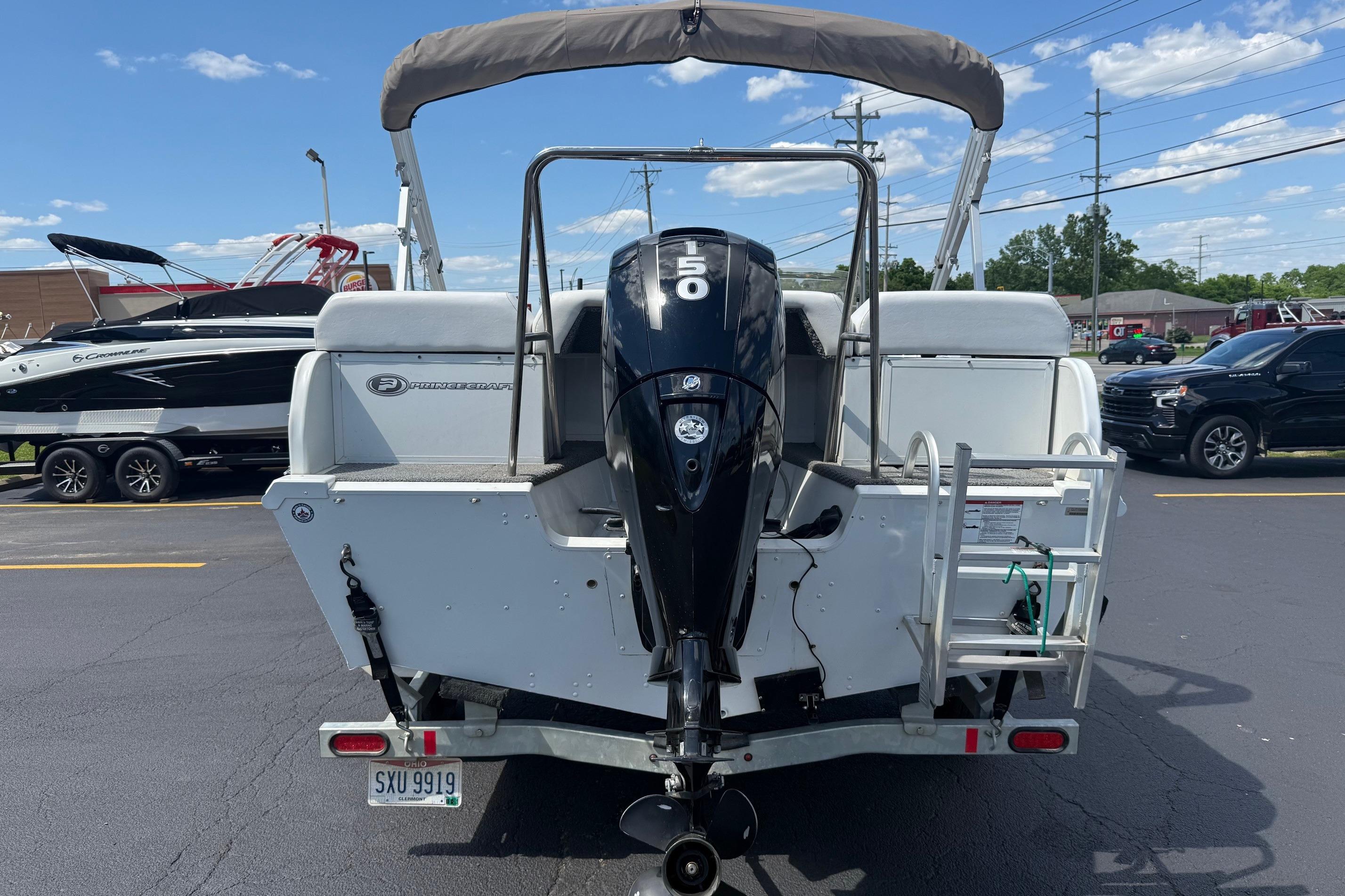 2019 Princecraft Ventura 190 boat with outboard motor, parked outdoors.
