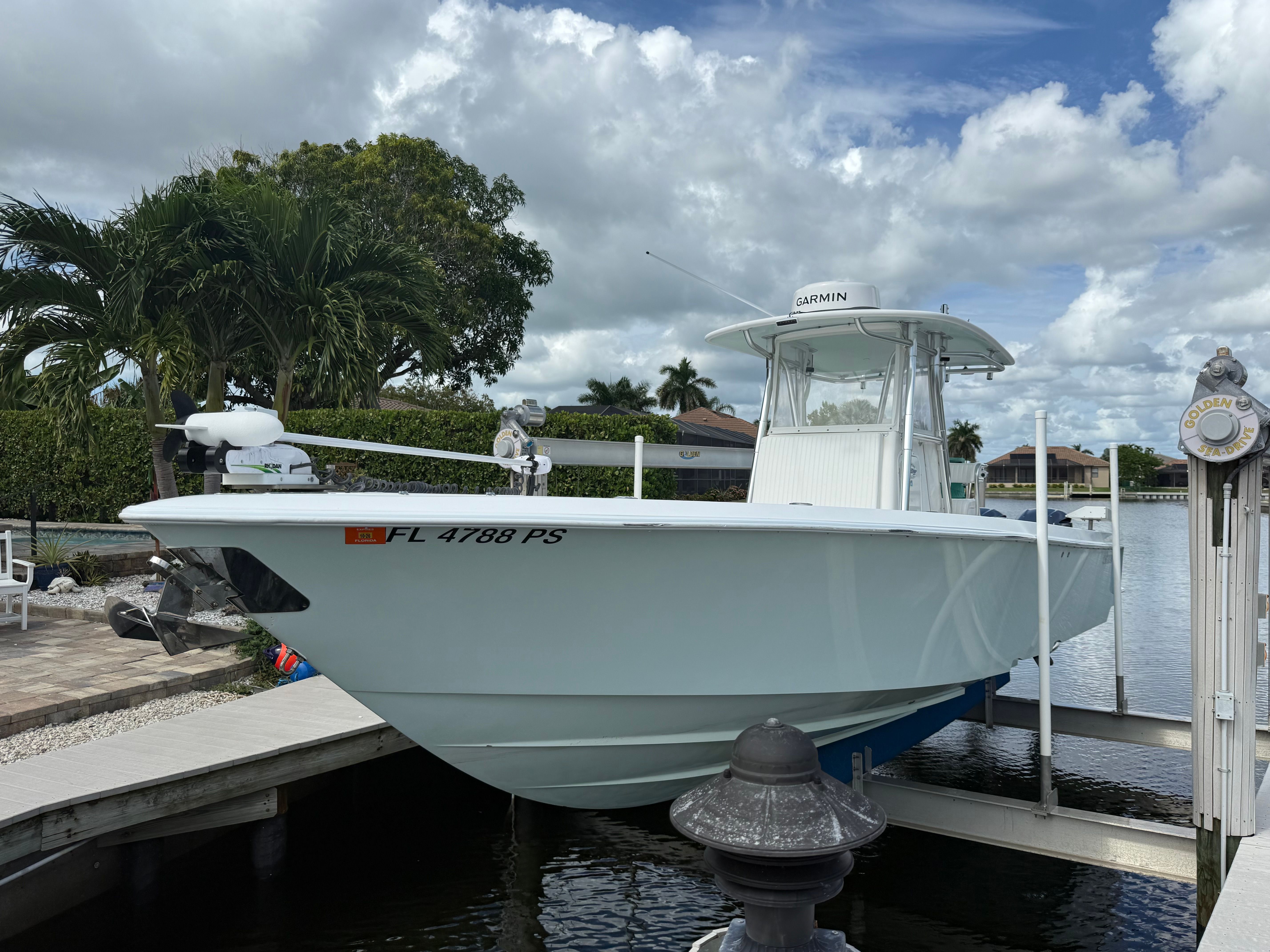 2012 Contender 32 ST boat docked under cloudy sky.