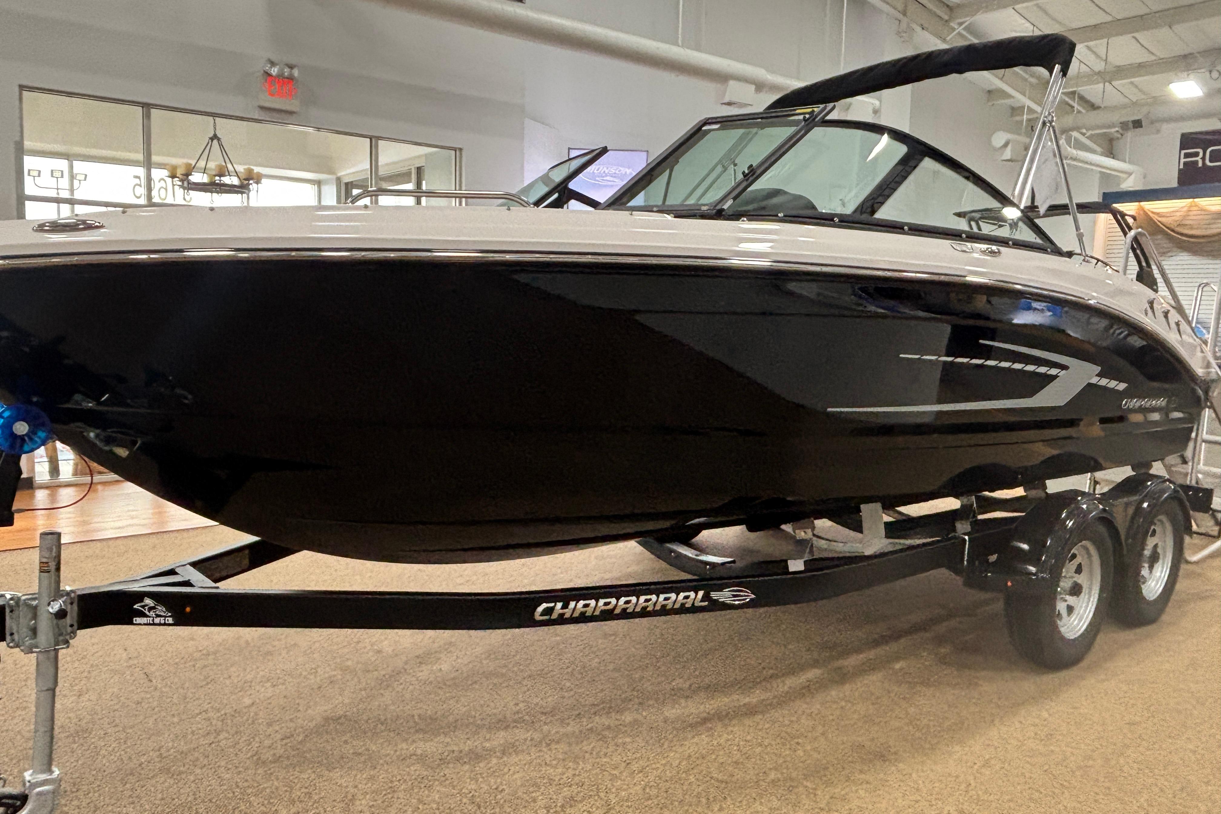2026 Chaparral 21 SSi boat on trailer in showroom.