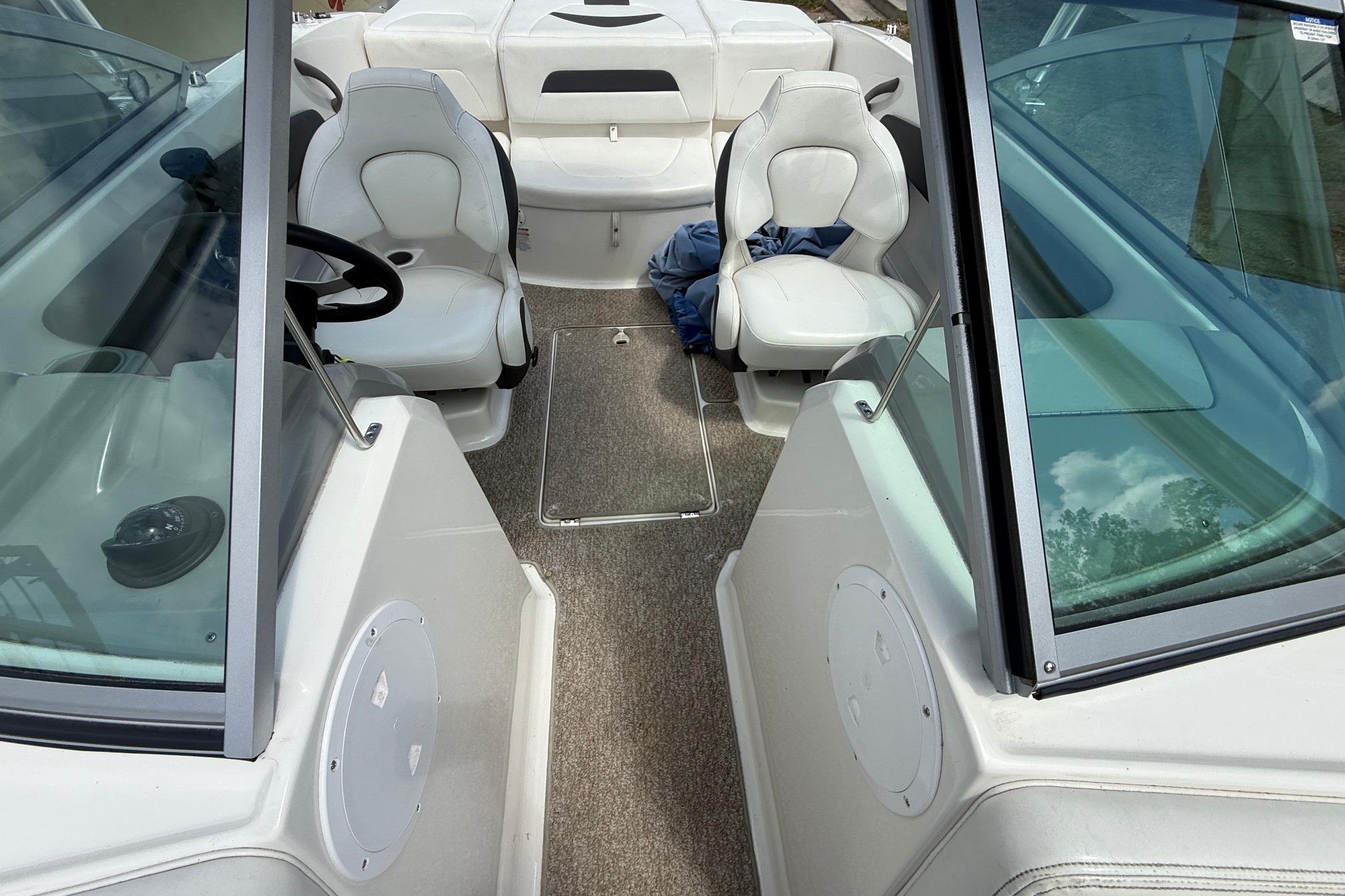 Interior of a 2012 Chaparral 18 H2O Sport boat with seating and steering wheel.
