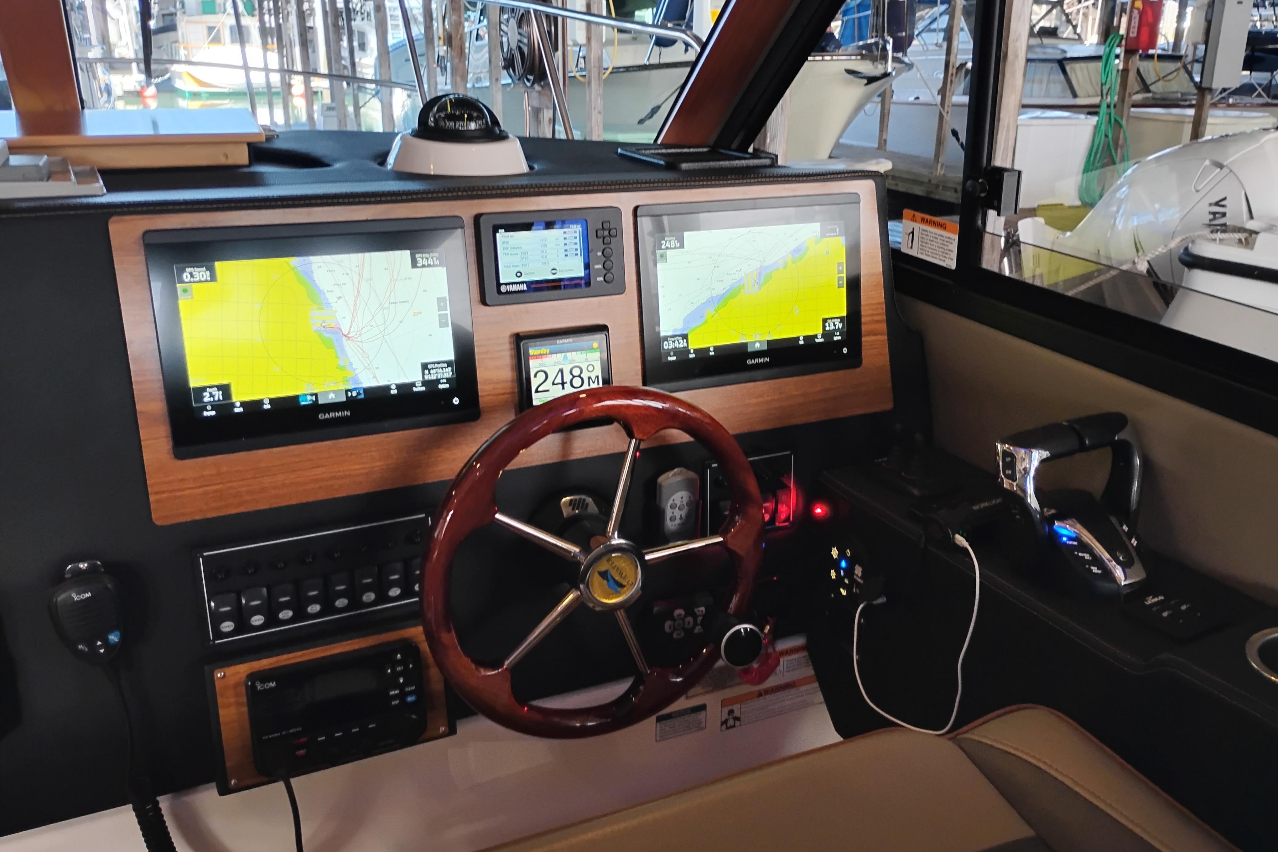 2022 Cutwater C-32 Coupe helm with navigation screens and steering wheel.