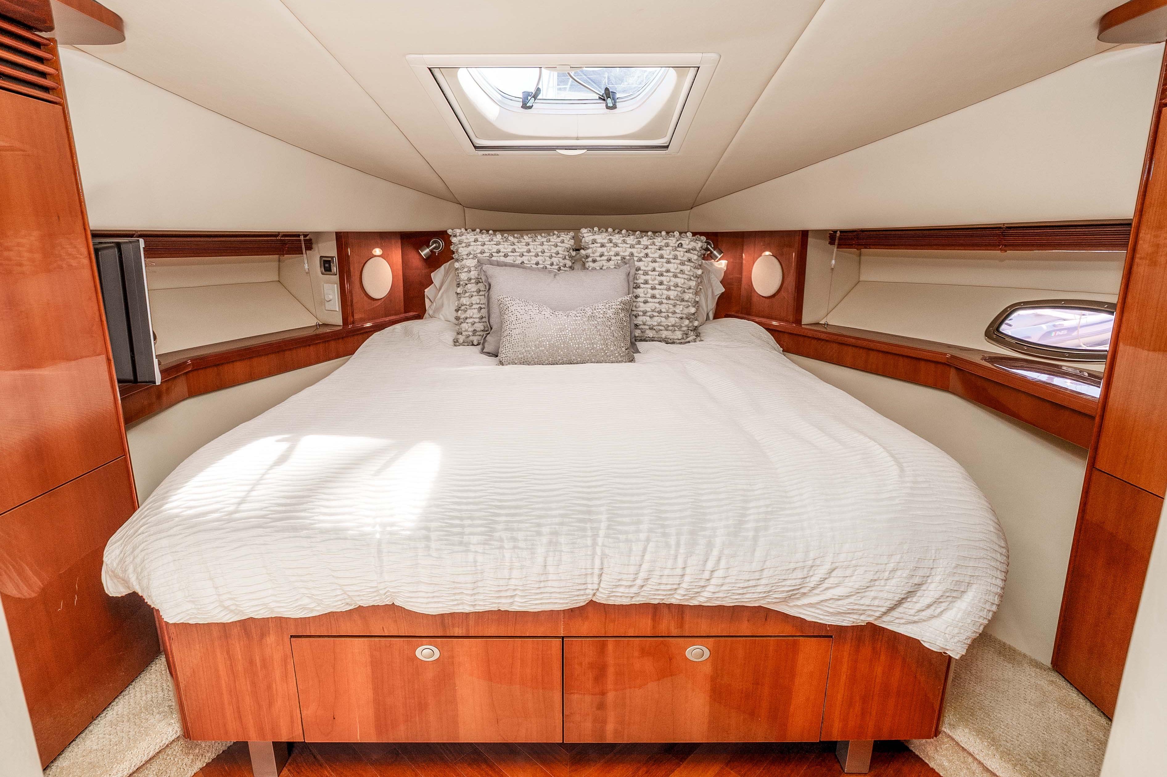 Luxurious cabin interior of 2007 Sea Ray 48 Sundancer yacht with elegant bedding.