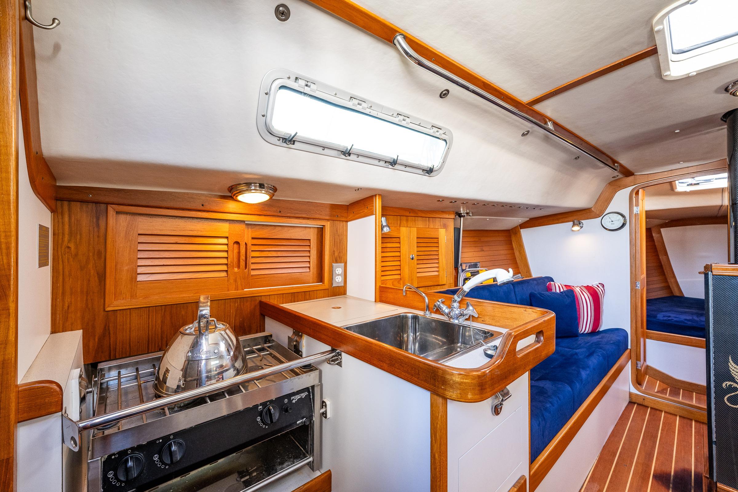 Interior of 2007 J Boats J/124 sailboat with cozy galley and seating area.