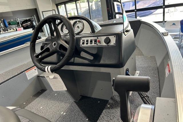 2027 Lund 1600 Fury SS boat dashboard with steering wheel and control panel.