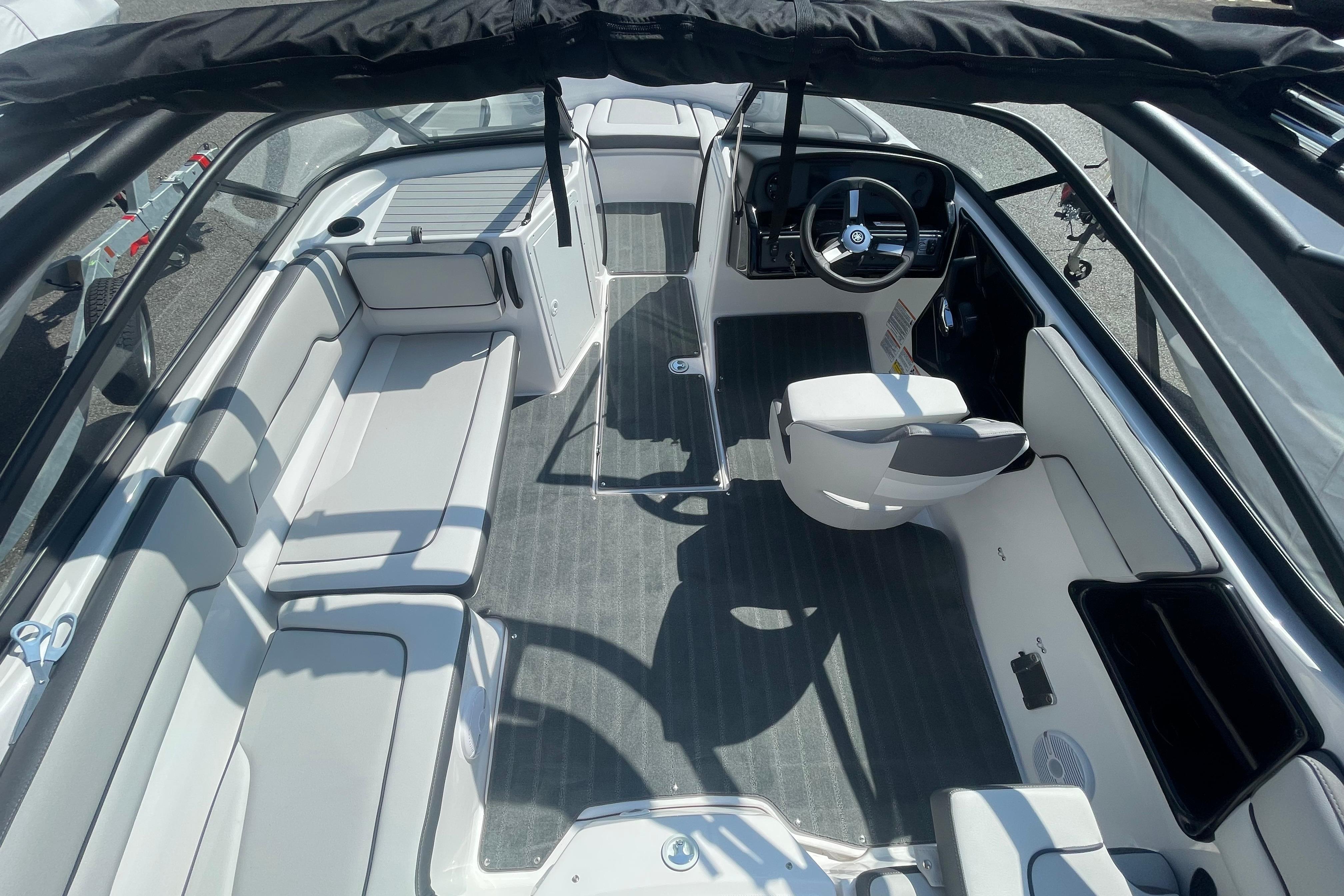 2026 Yamaha Boats AR190 interior with seating and steering wheel, showcasing modern design.