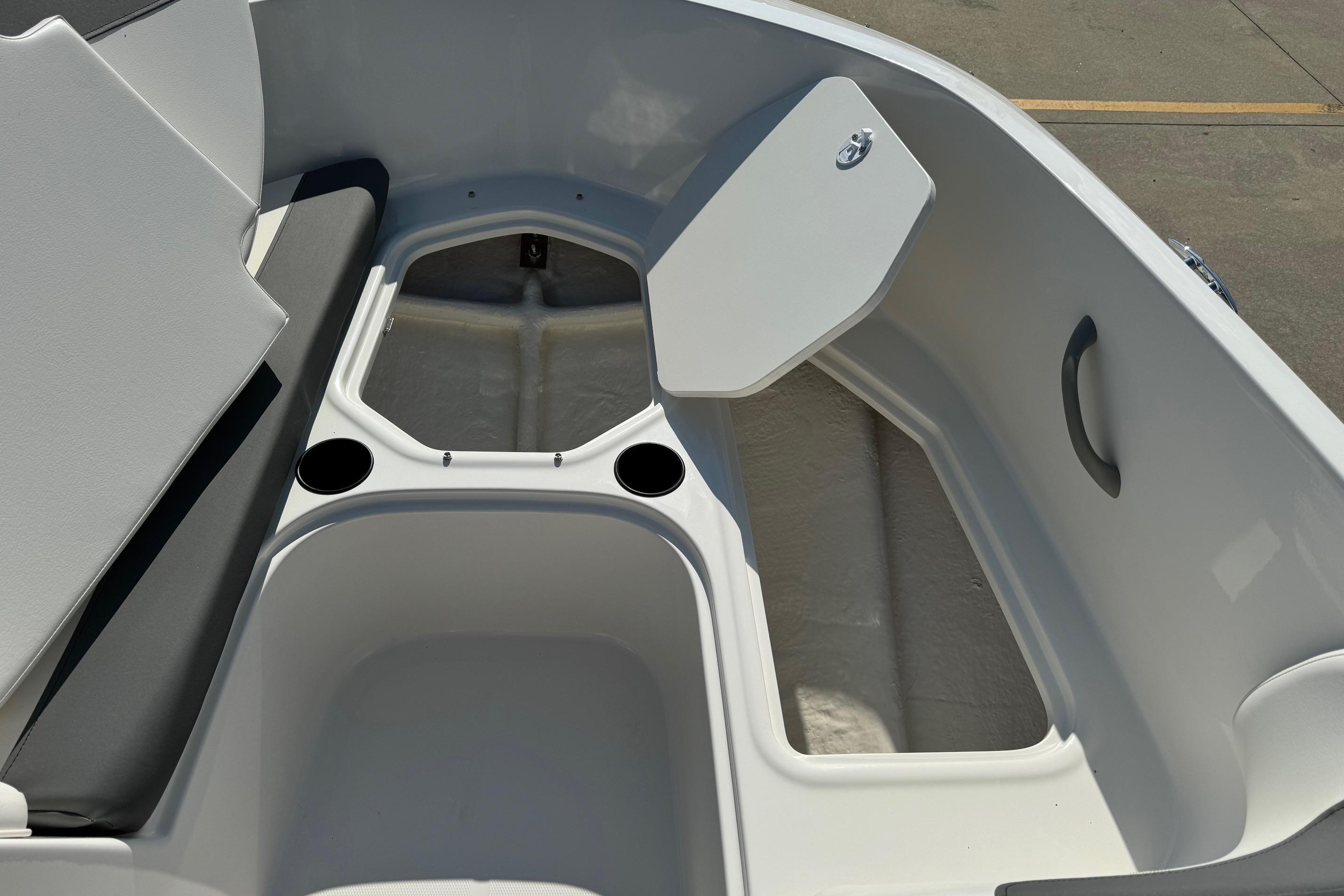 2025 Bayliner Element E16 boat interior with open storage compartment and cup holders.